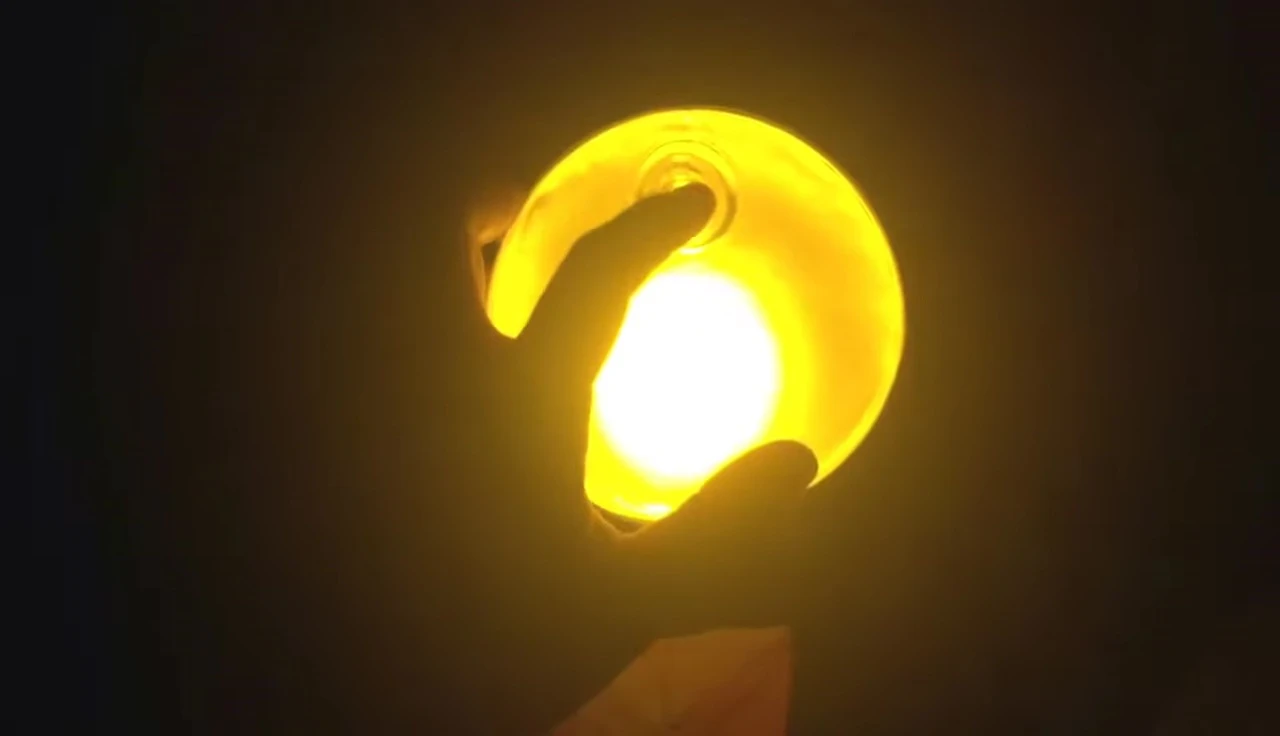 The Luci candle illuminated, showing its light output.