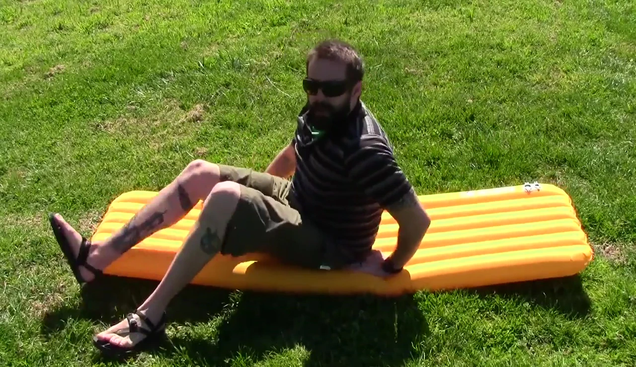 The reviewer lying on the Big Agnes Air Core Ultra sleeping pad, demonstrating its comfort.