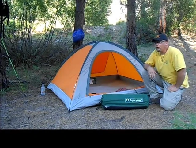 Speaker showing various expensive sleep pads at Sportsman's Warehouse.