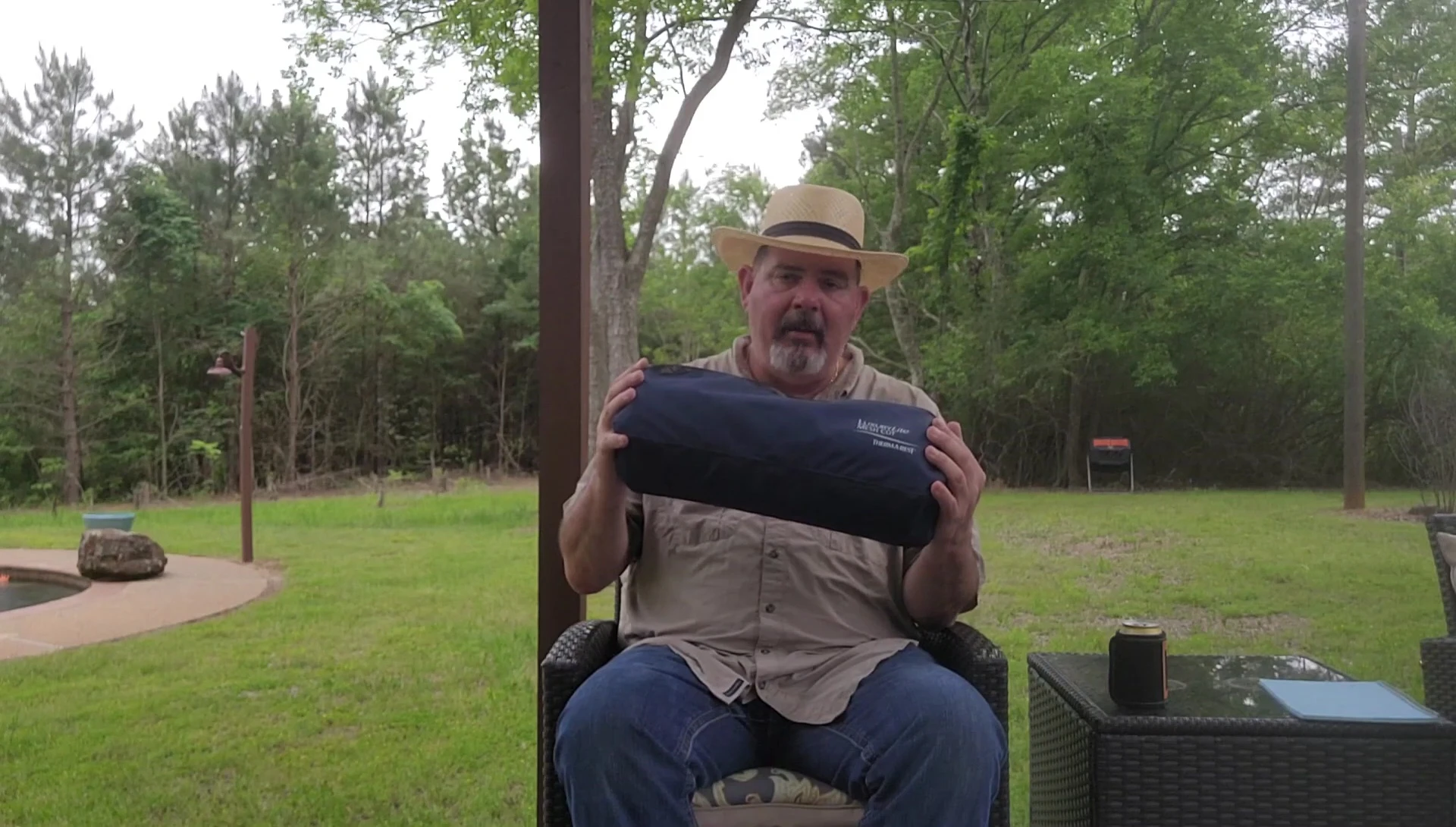 The narrator demonstrating the cot's size and comfort