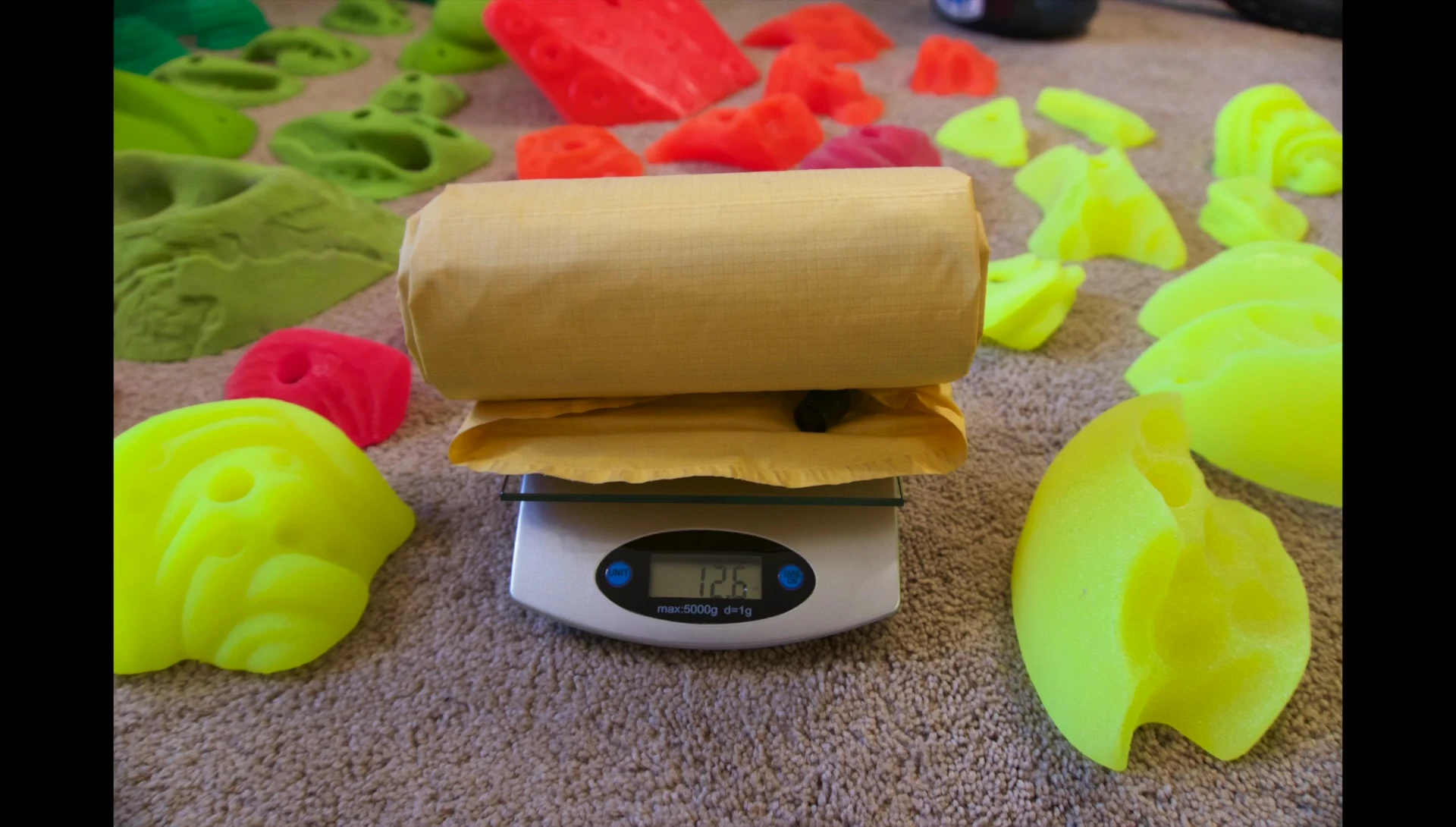 The Thermarest Xlite sleeping pad being weighed on a scale.