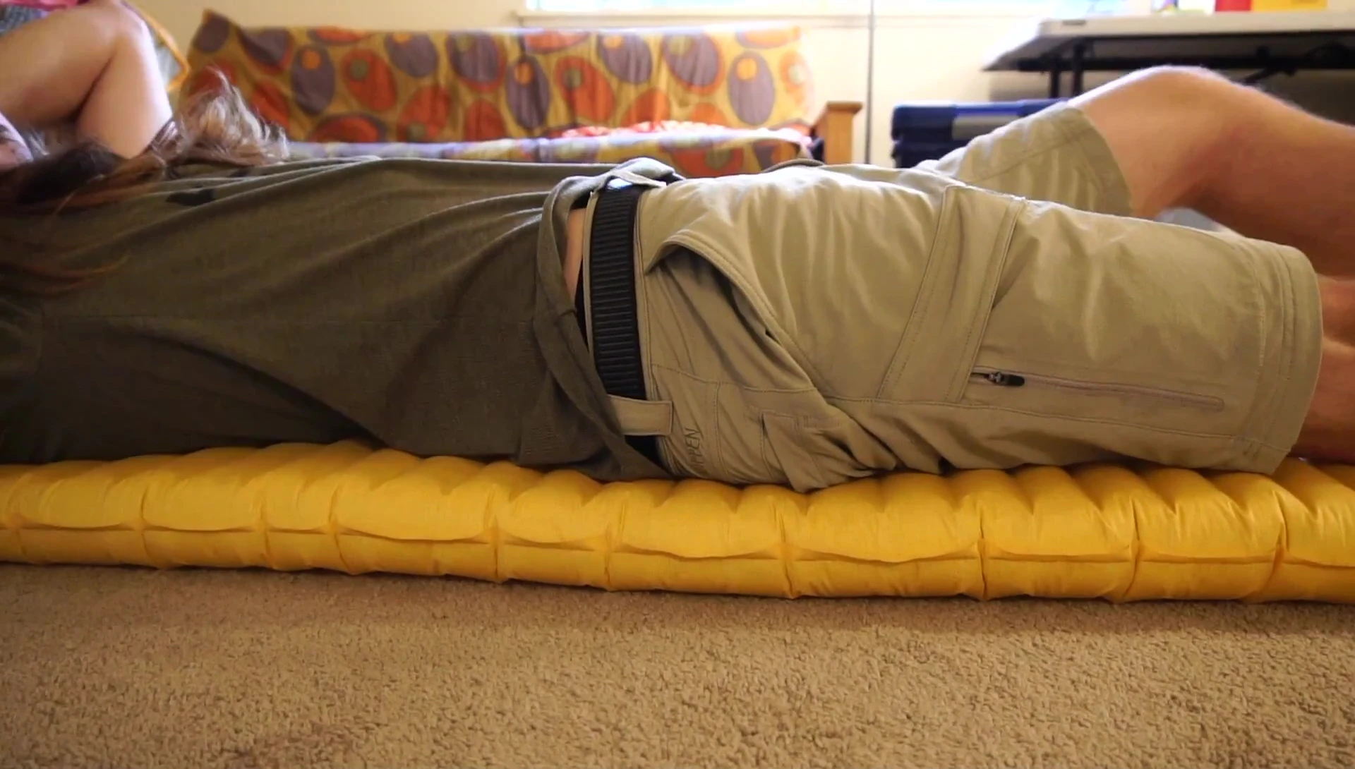Person sitting on the Thermarest Xlite, demonstrating its adjustability.