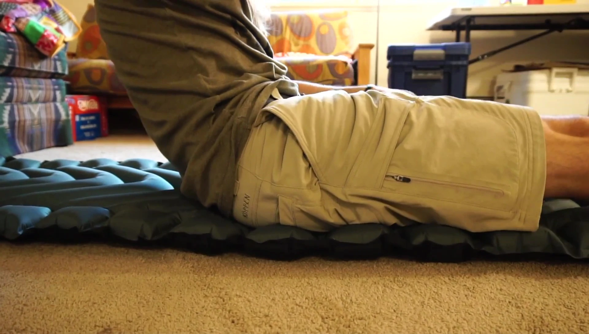 Person sitting on the Klymit Static V Ultralight, showing potential bottoming out.