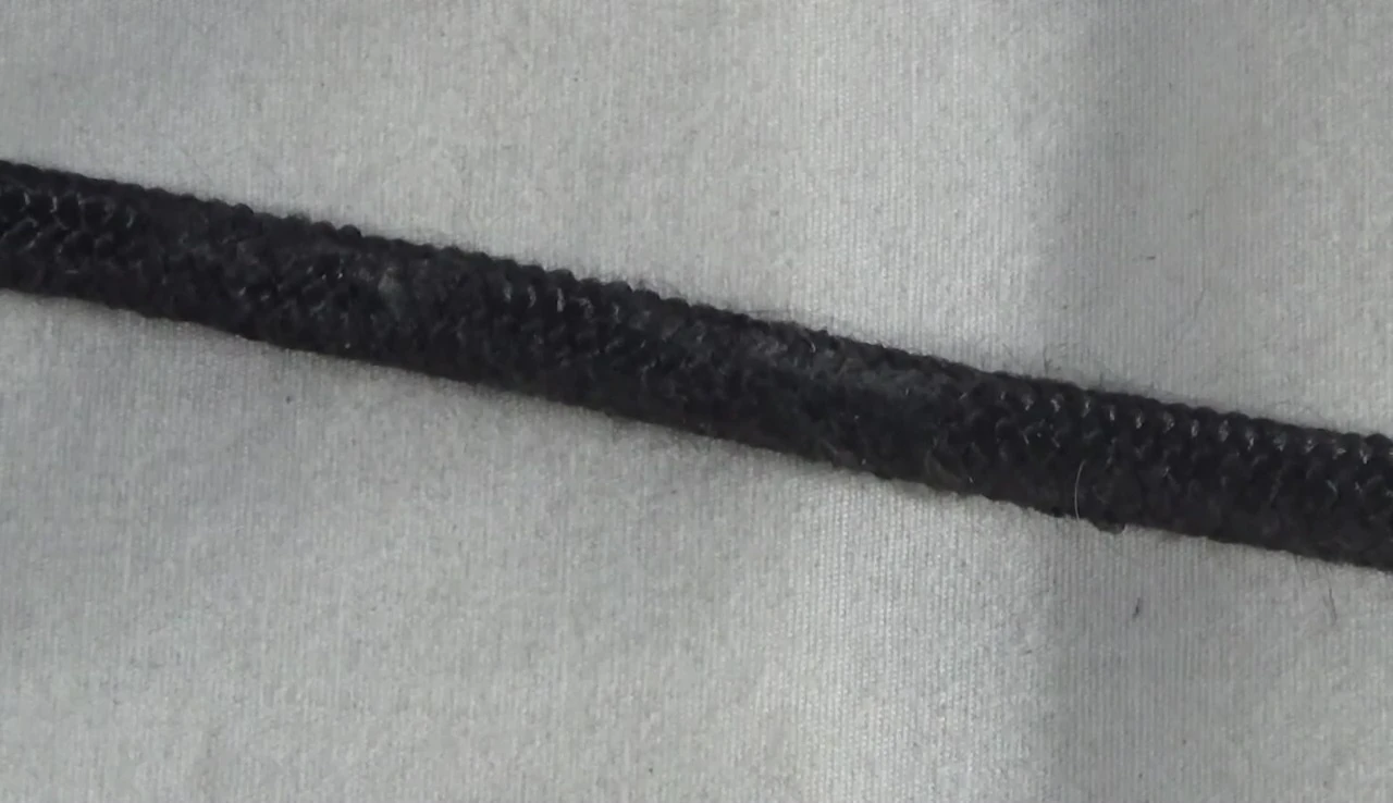 The end of the rope where the knot was tied, illustrating the fraying.