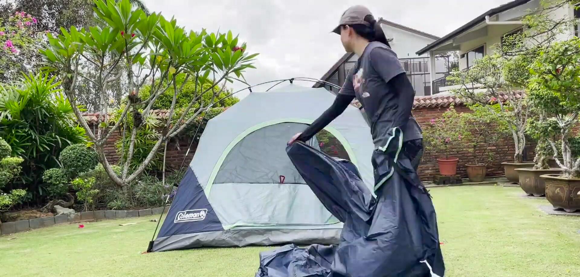 Drapping the rainfly over the tent
