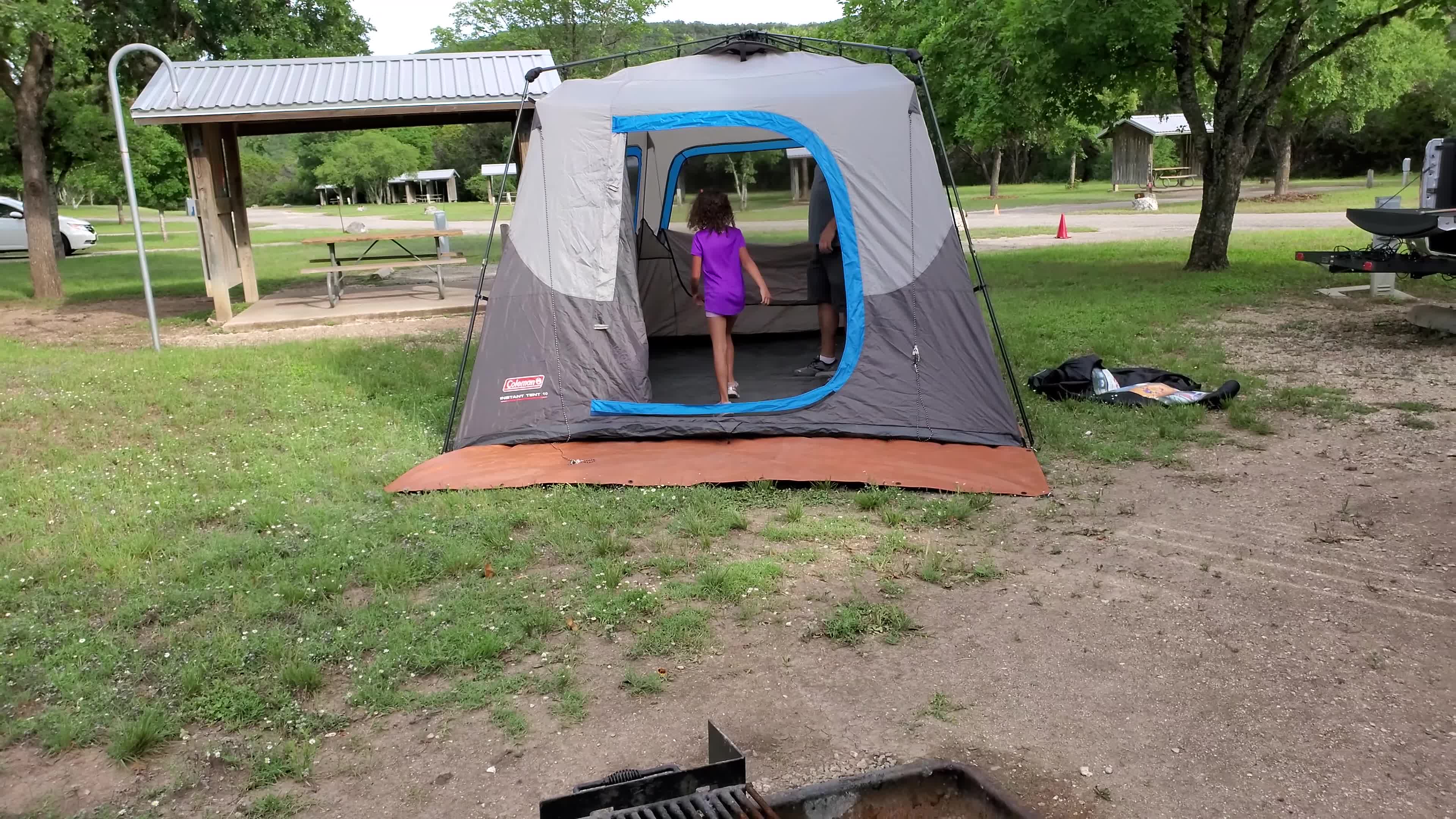 Person demonstrating the ease of setting up the tent