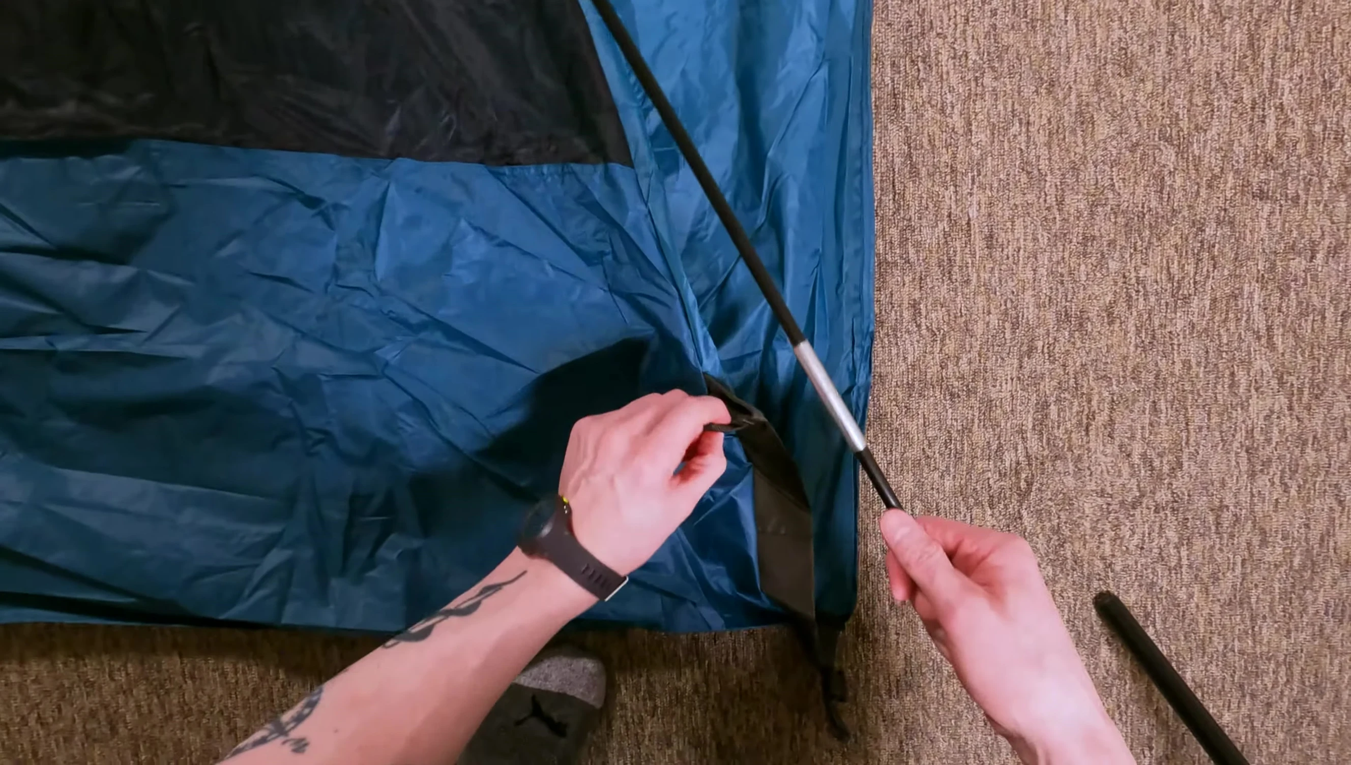 Inserting tent poles into the sleeves.