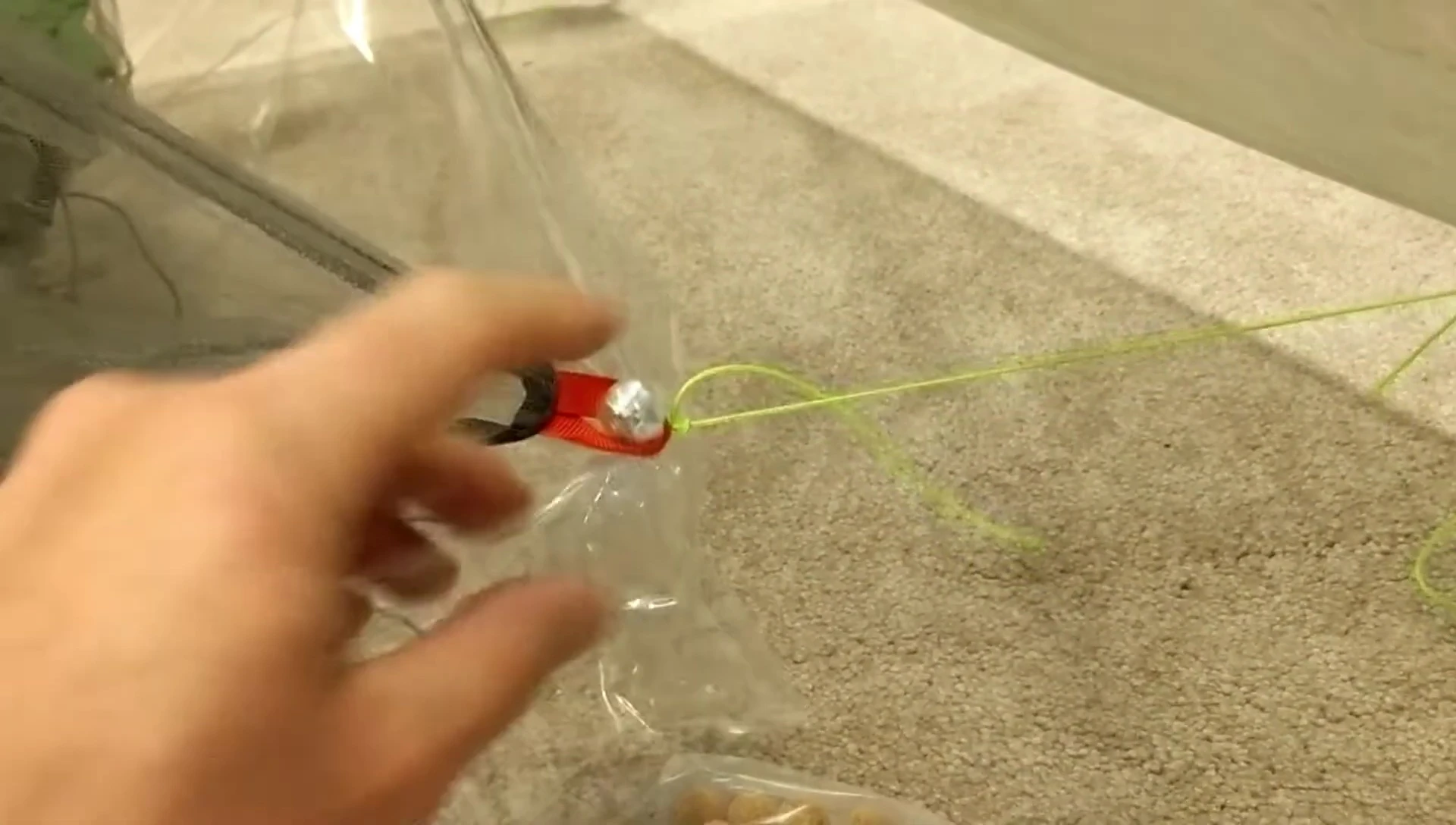 Demonstrating the knot used to secure the Polycryo to the buttons.