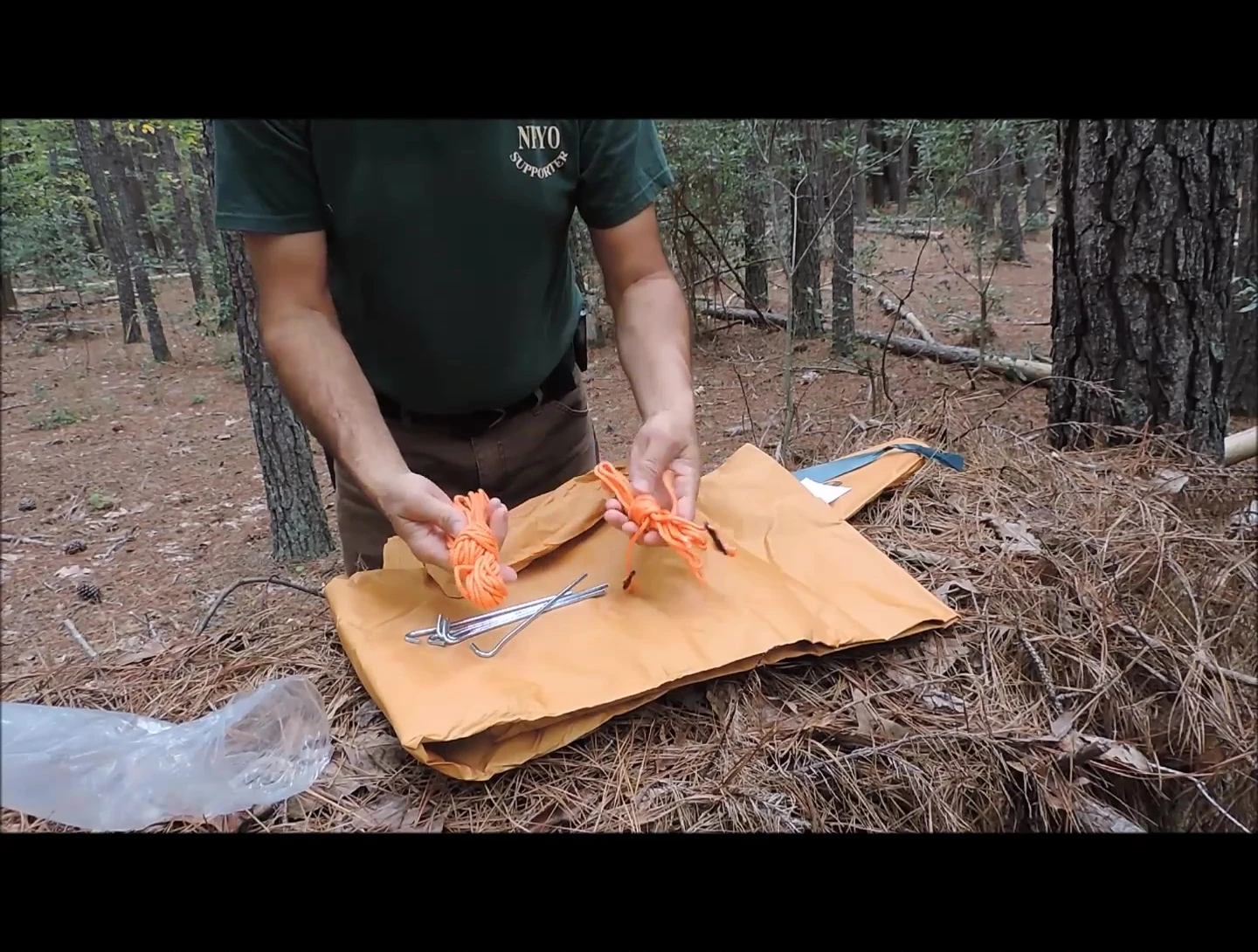 The accessory kit laid out, showing stakes and cordage.