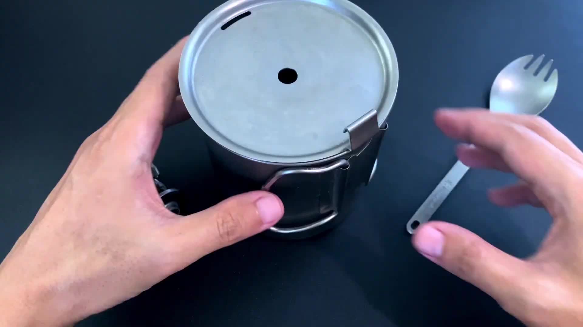 Close-up of the Trek 700 titanium mug with its foldable handles.