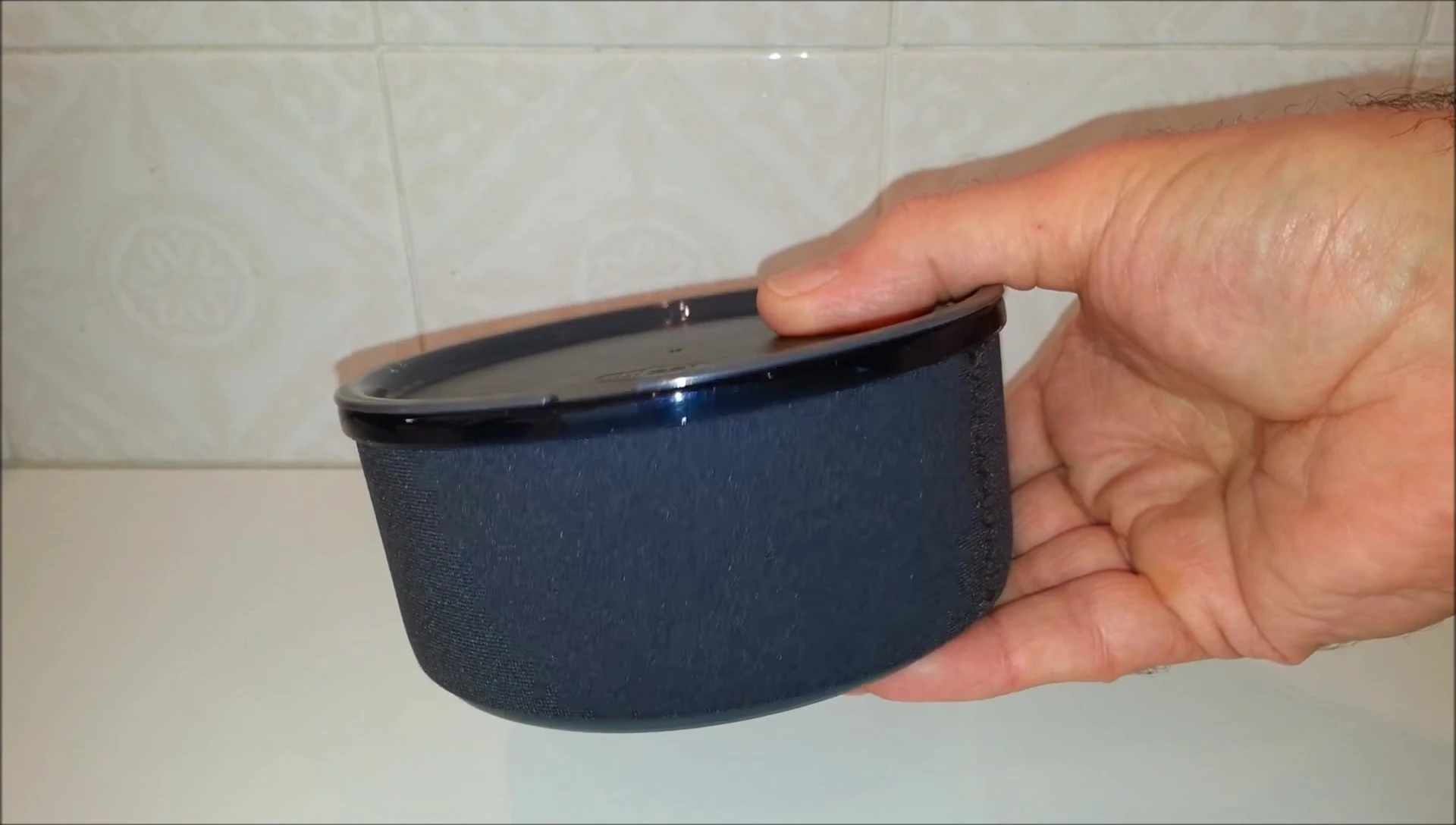 The cup with various items inside demonstrating its capacity.