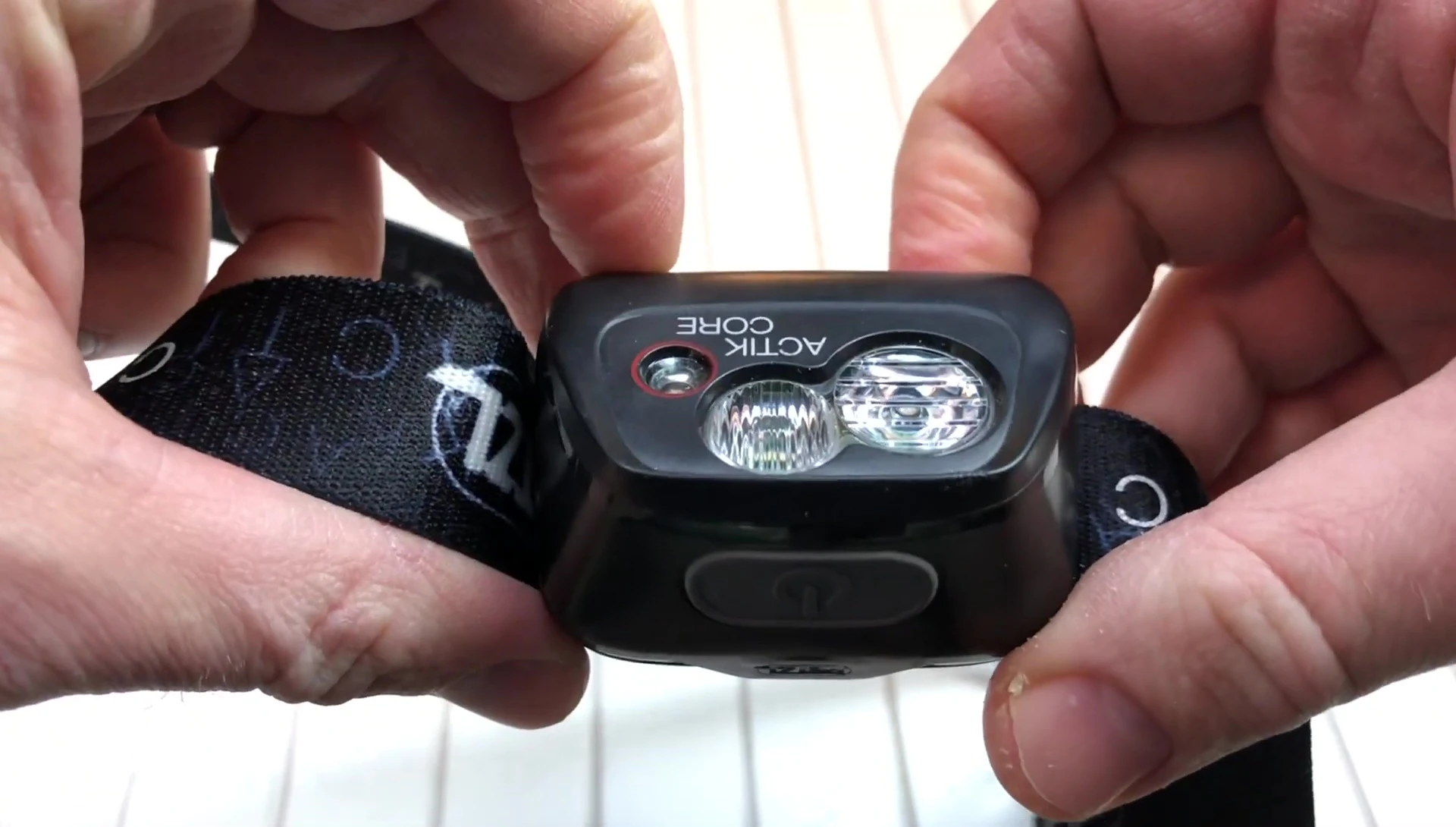 Close-up of the headlamp strap and buckle showing the adjustable features.