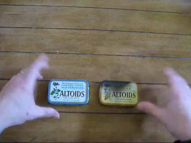A collection of Altoids tins being prepared for the candle-making process.