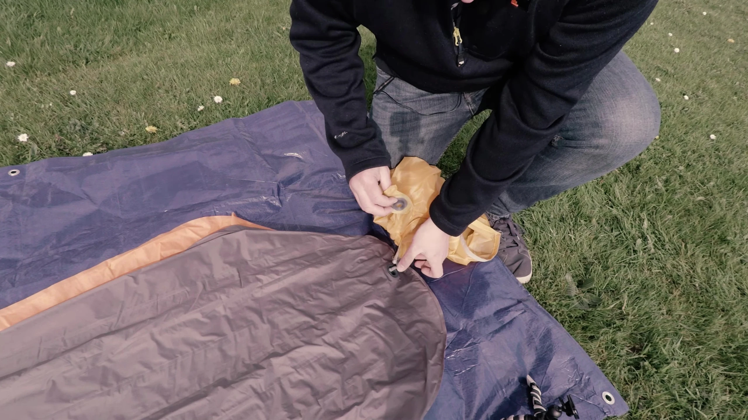 The process of inflating the sleeping pad using the dry sack.
