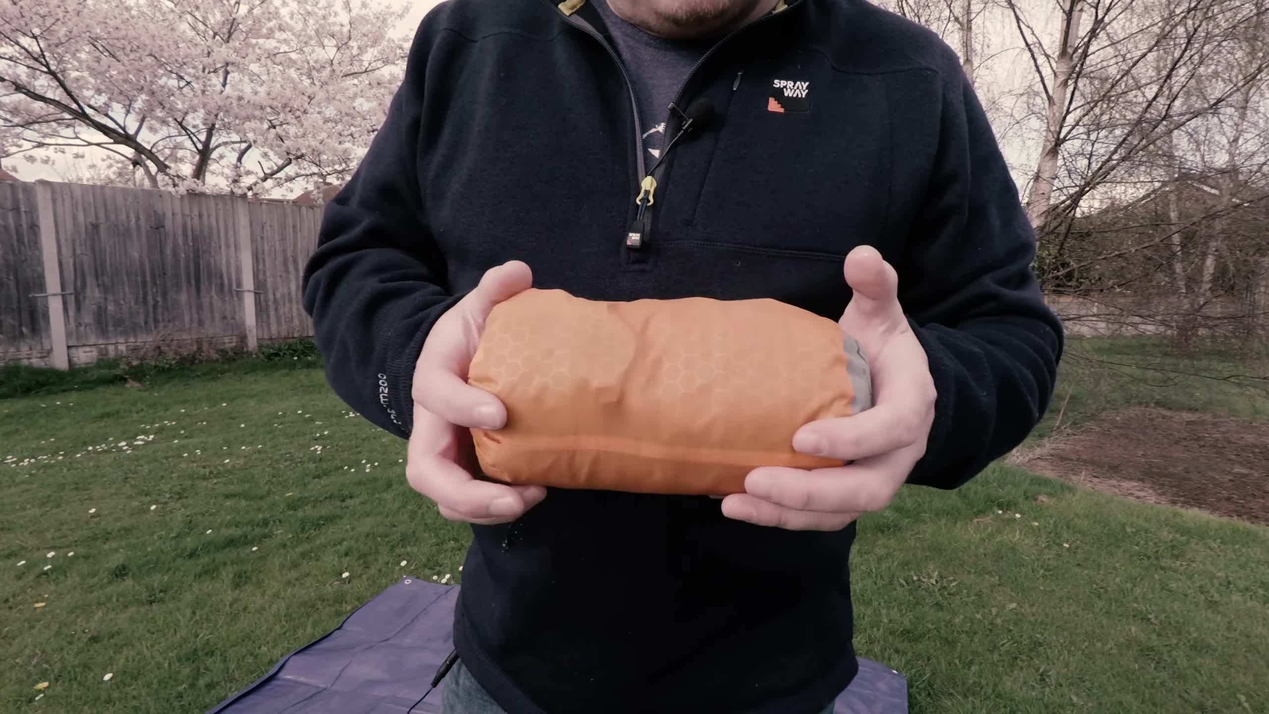 The Exped Synmat Hyperlite sleeping pad next to a soda can, highlighting its compact size.