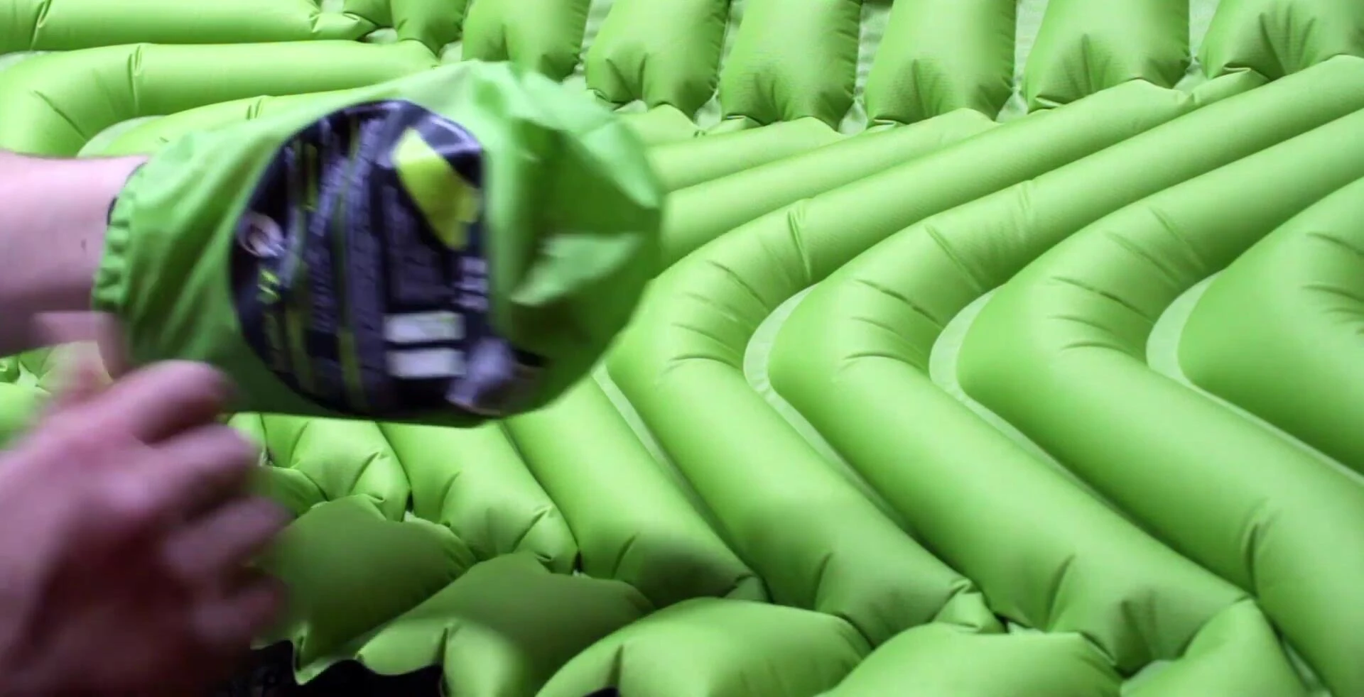 The Klymit Static V2 pad being packed into its stuff sack