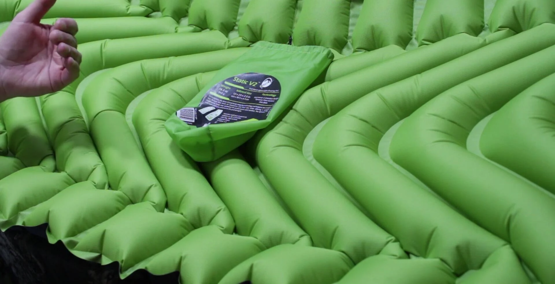 Person laying on the Klymit Static V2 sleeping pad demonstrating comfort and insulation