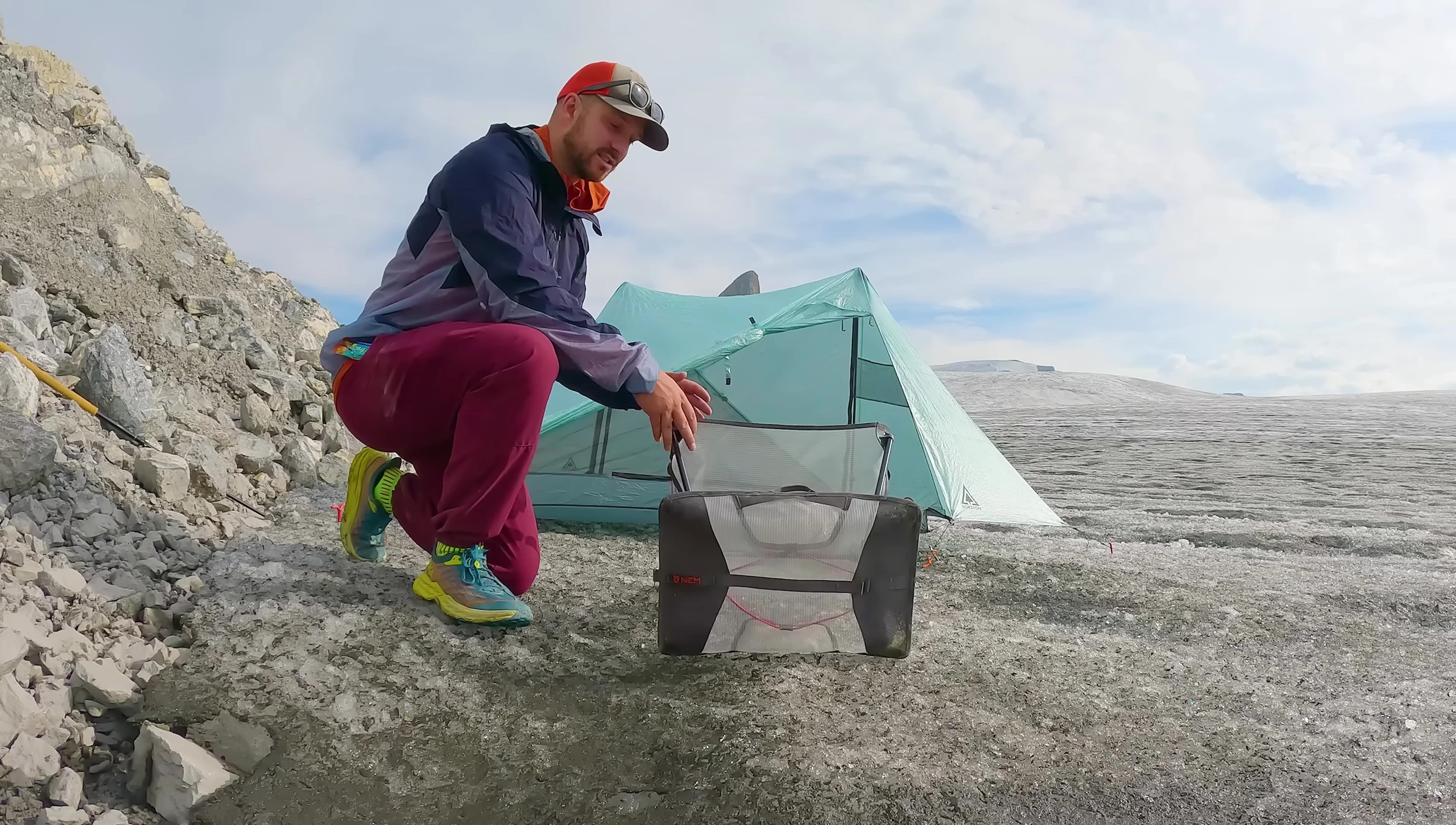 The chair's carrying case being used as a groundsheet.