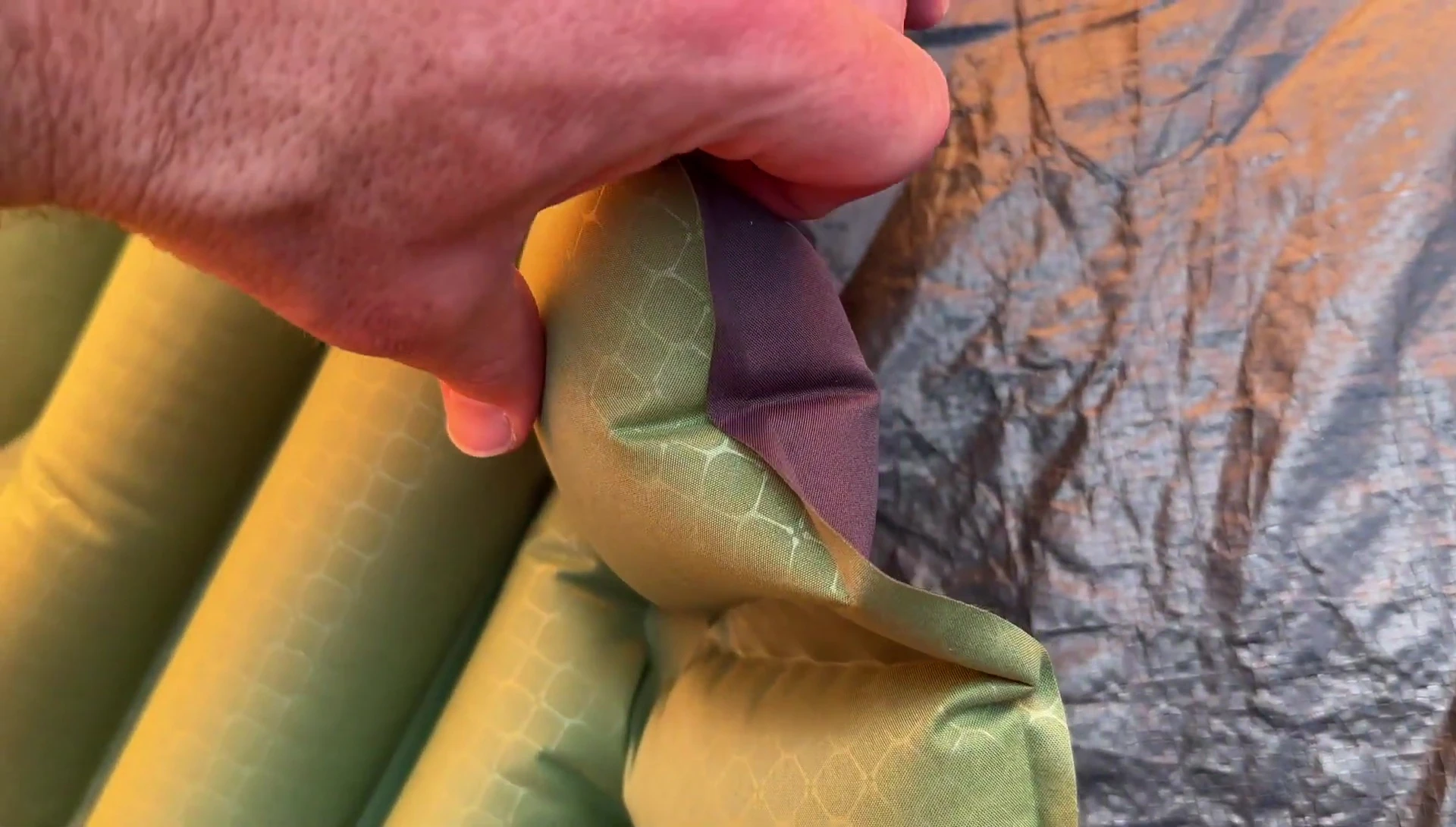 Close-up showcasing the durable polyester fabric of the sleeping pad.