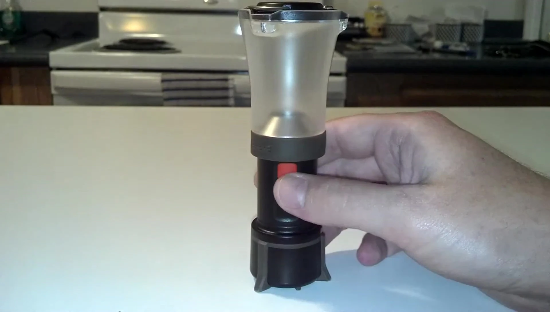 Close-up showing the Orbit's single power button and hanging hooks.