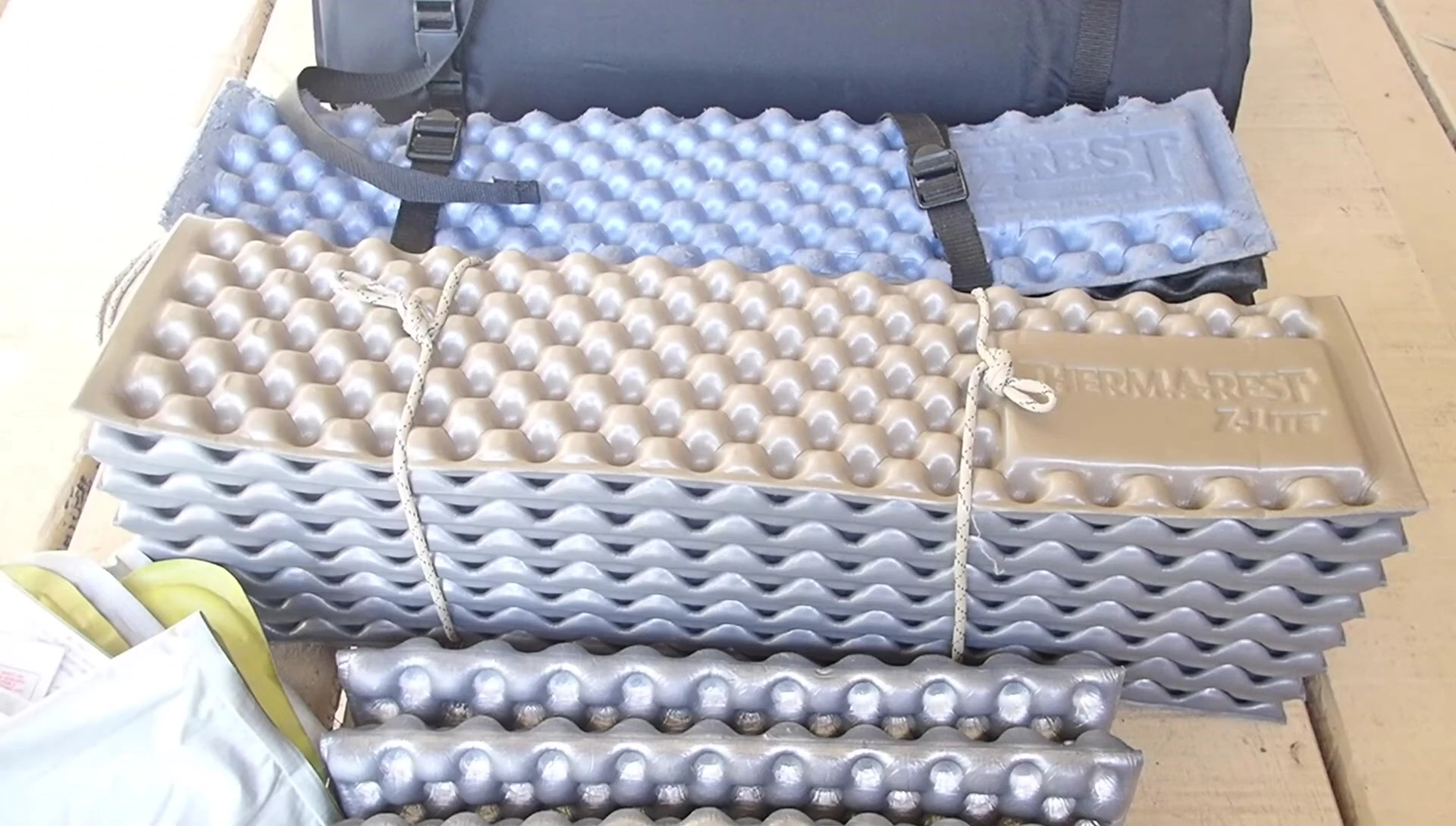 The speaker demonstrating the sleeping pad's use on an uneven surface.
