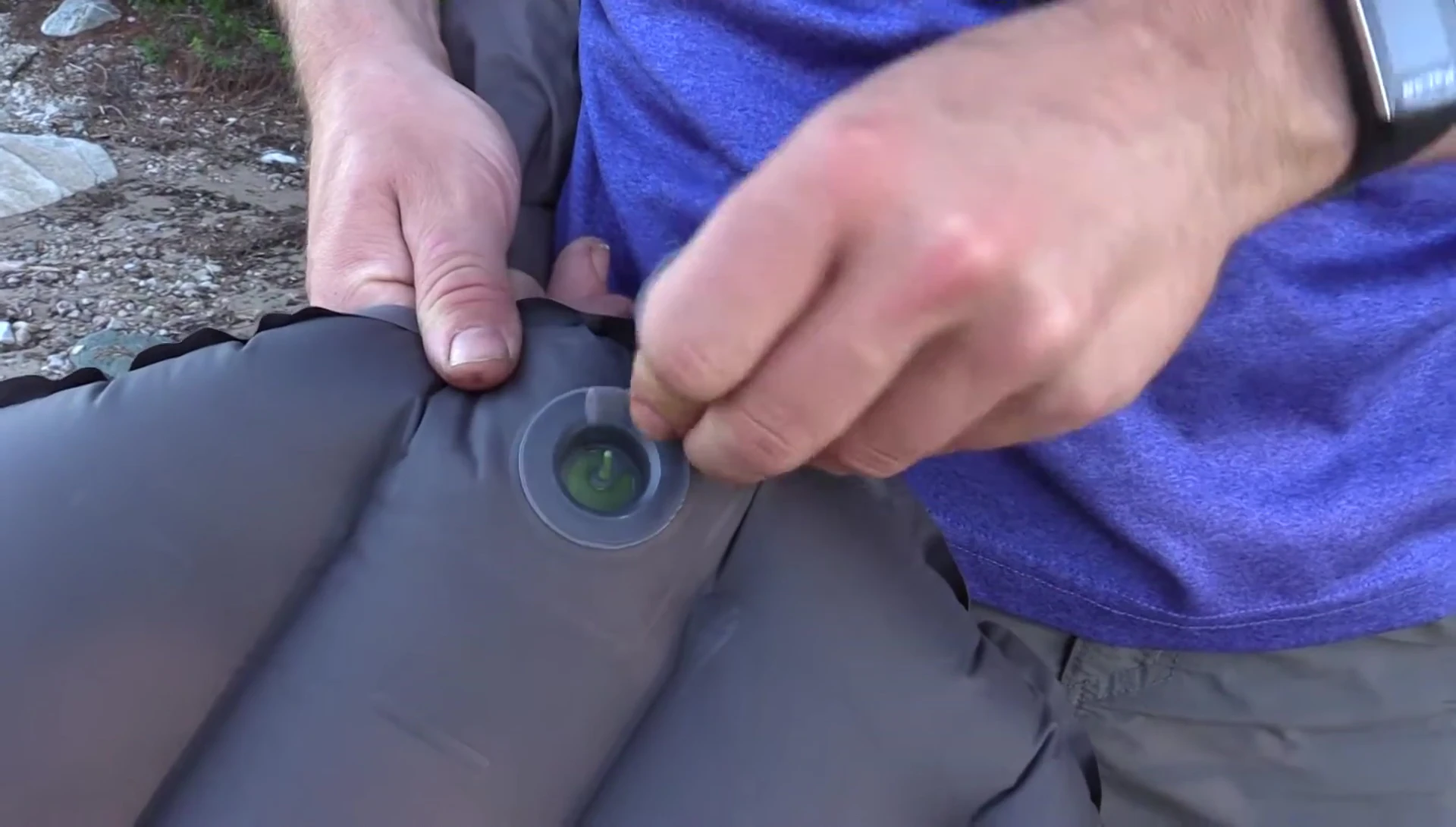 Opening the one-way valve to deflate the mat.