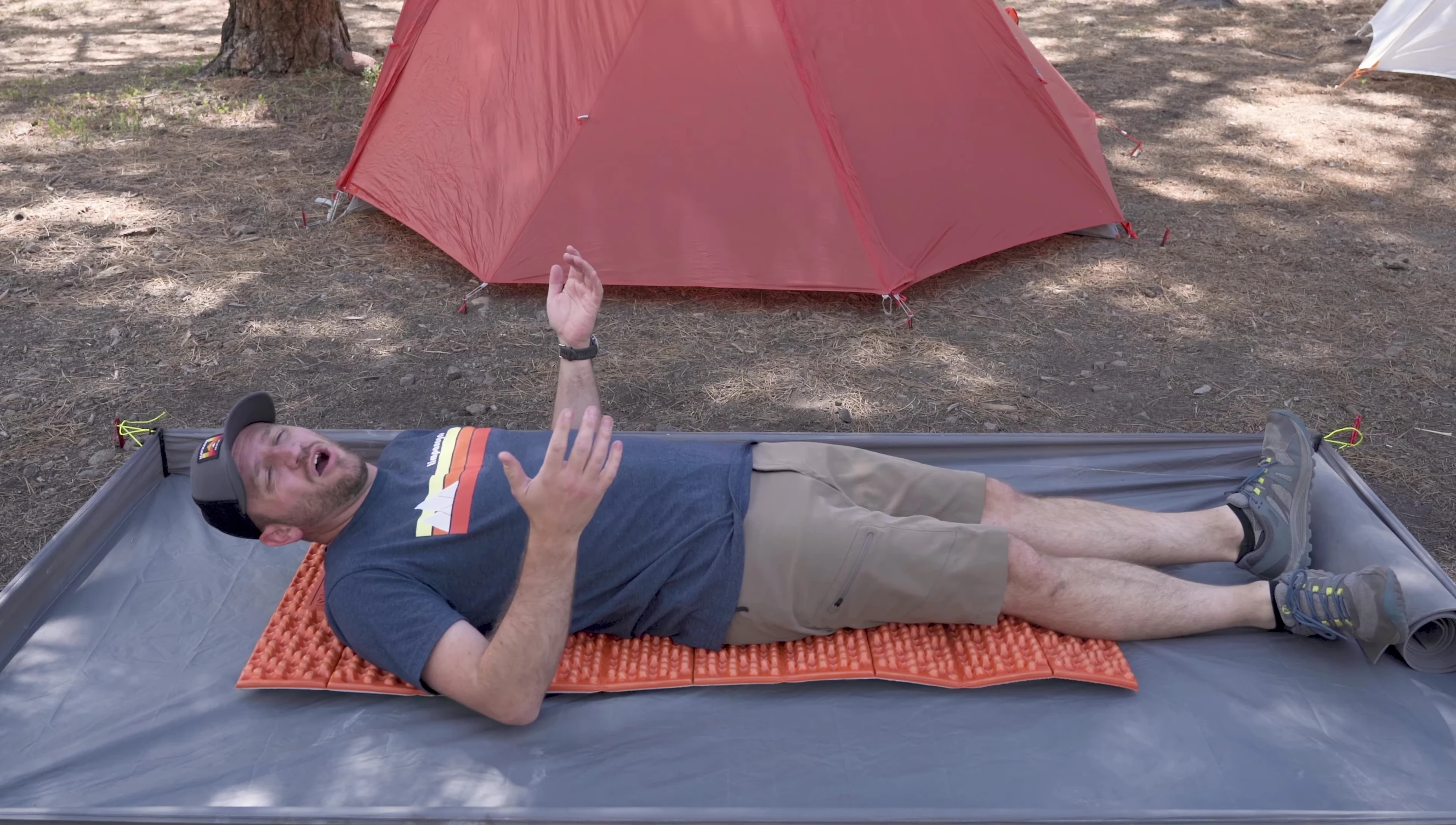 Person demonstrating how close to the ground a closed-cell pad is.