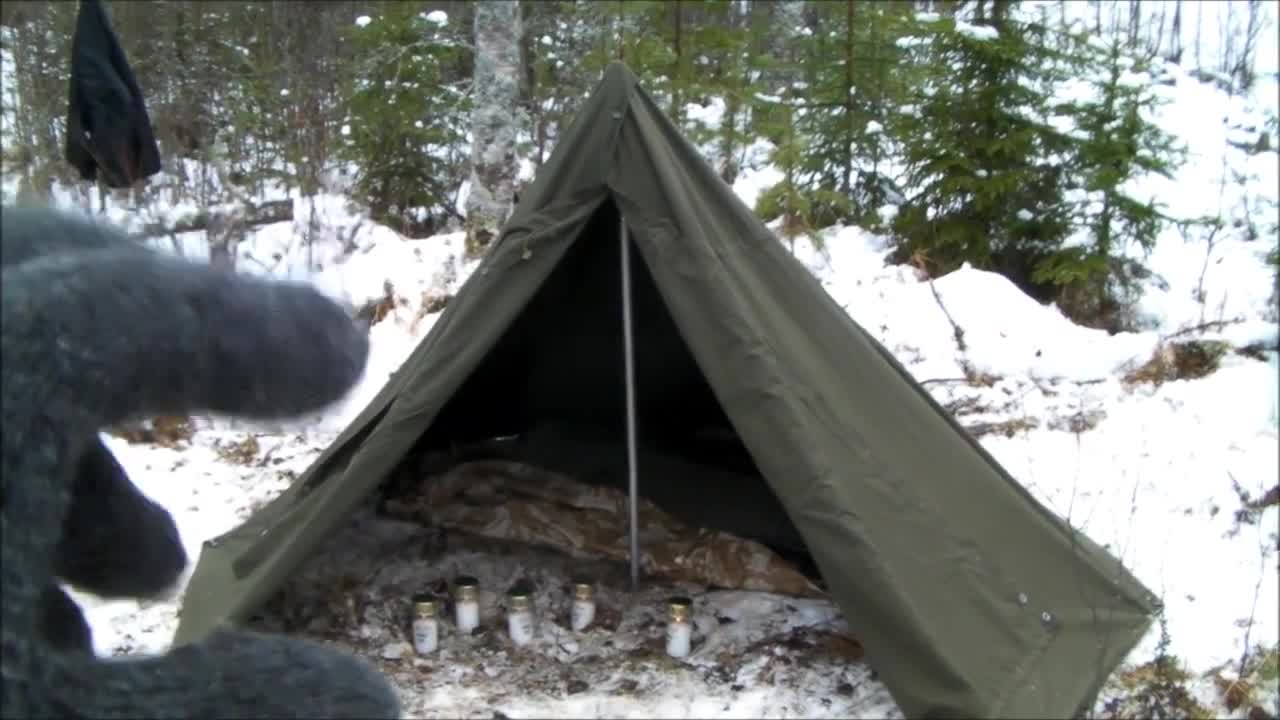 Close-up of the candles being placed inside the tent.