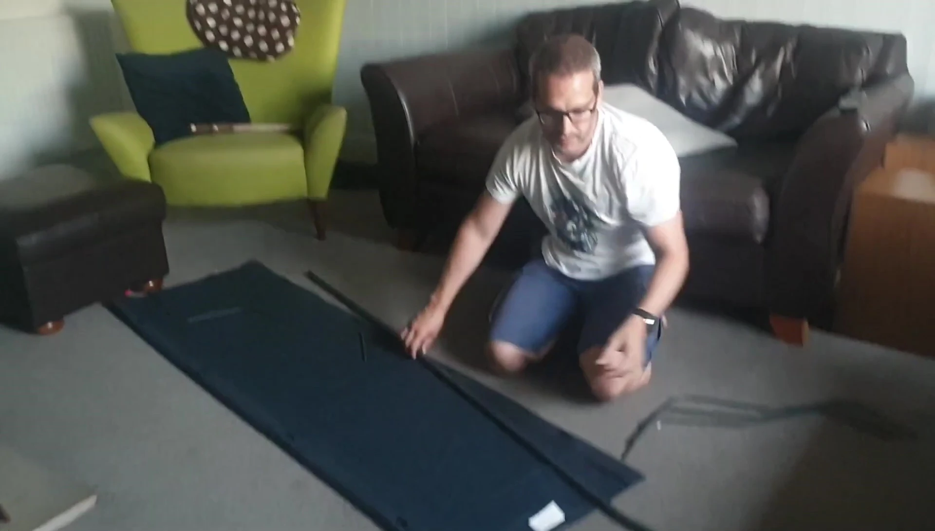 Pushing the legs into the larger holes of the side supports.