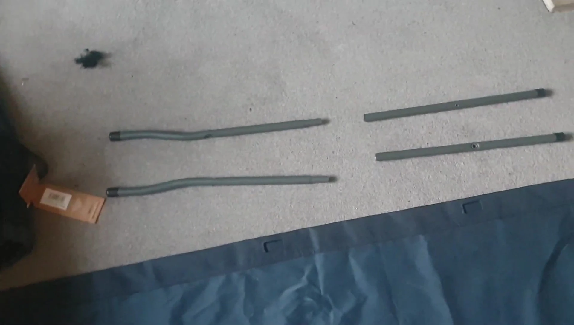 Inserting the side supports into the pockets of the camp bed cloth.