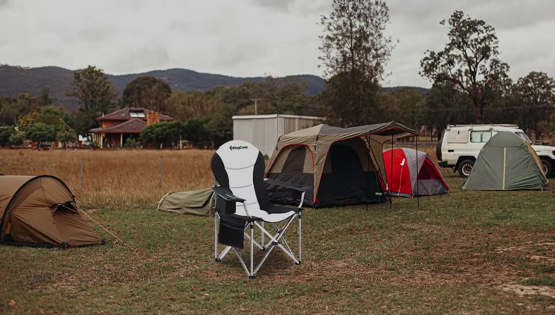 The King Camp chair being folded or unfolded, showcasing its ease of use.