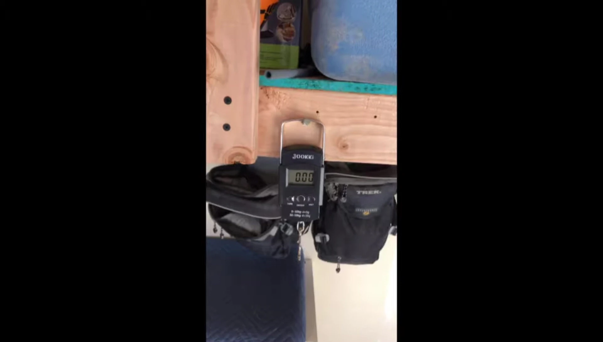 The sleeping bag being weighed on a scale.