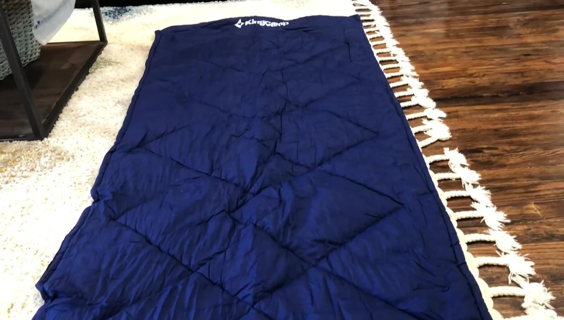The sleeping pad being used on a couch as extra cushioning.