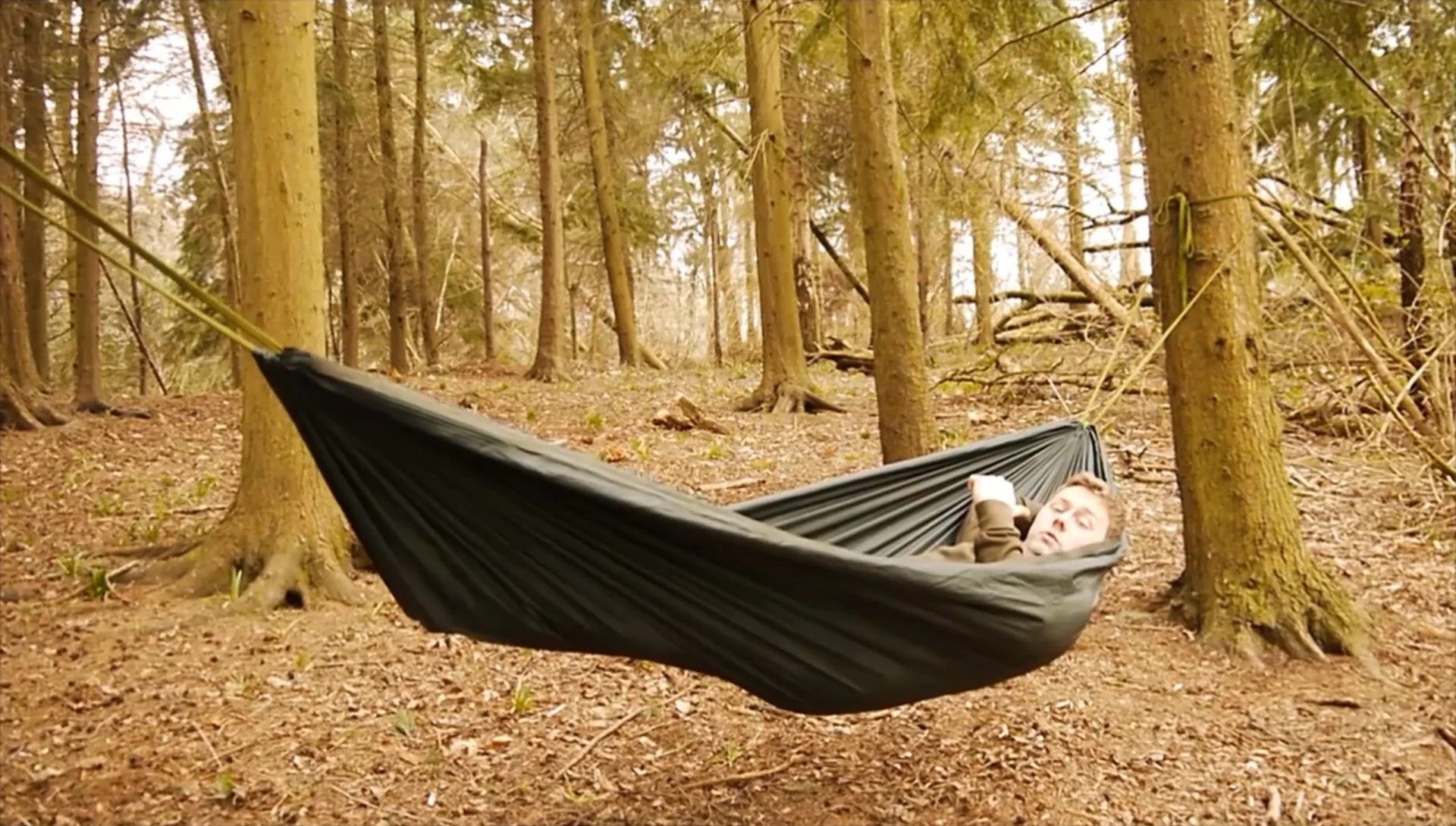 A person demonstrating the diagonal lay in a hammock for optimal comfort.