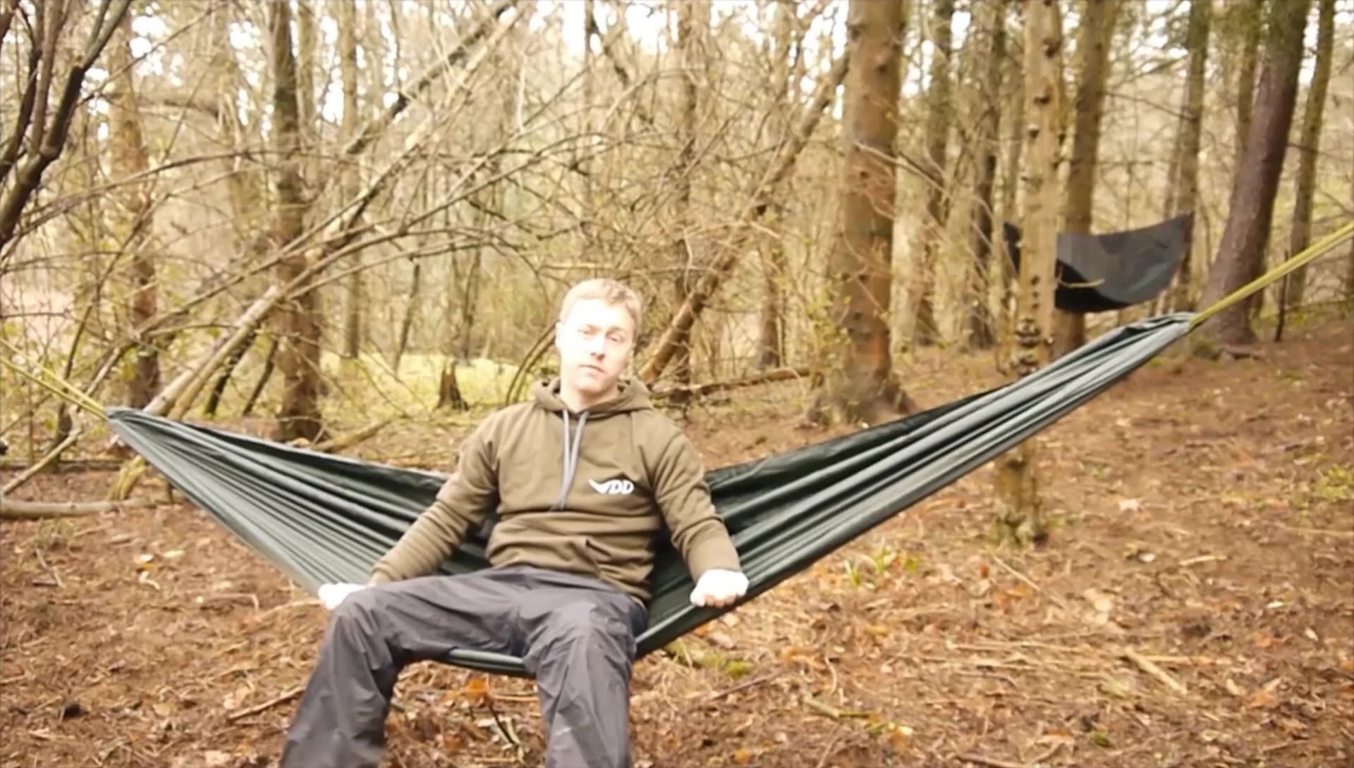 A person relaxing in a hammock, showcasing its versatility as both a bed and a chair.