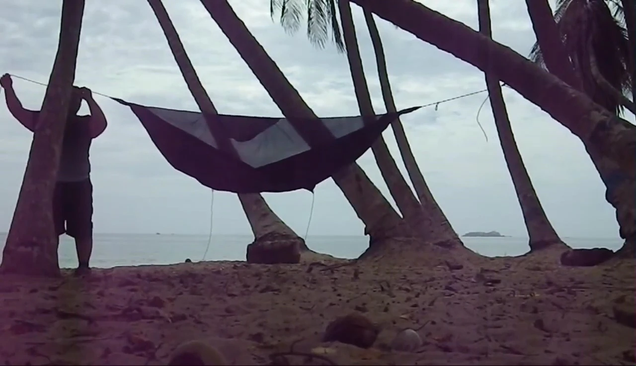 Hammock being hung using the included ropes and carabiners.