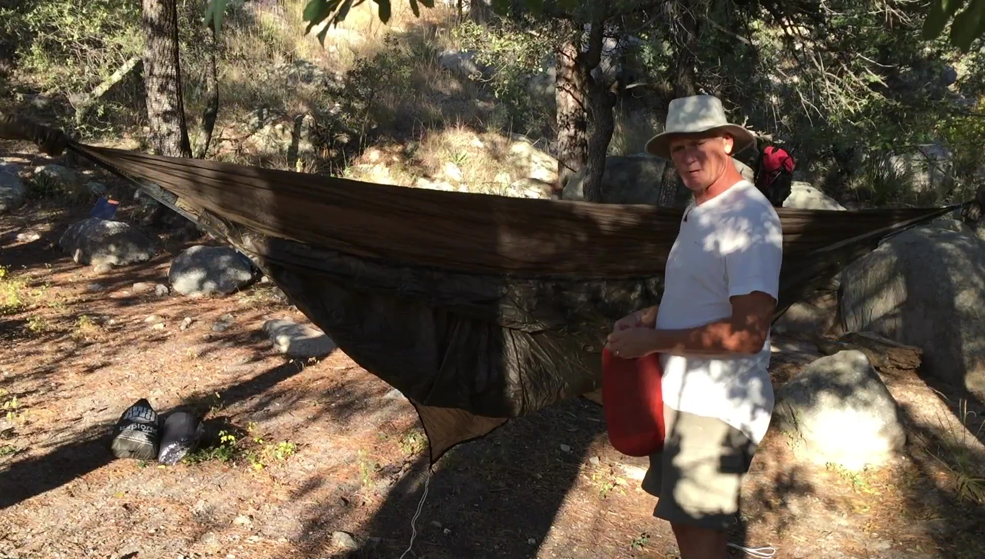 Hennessy SuperShelter being placed into the hammock