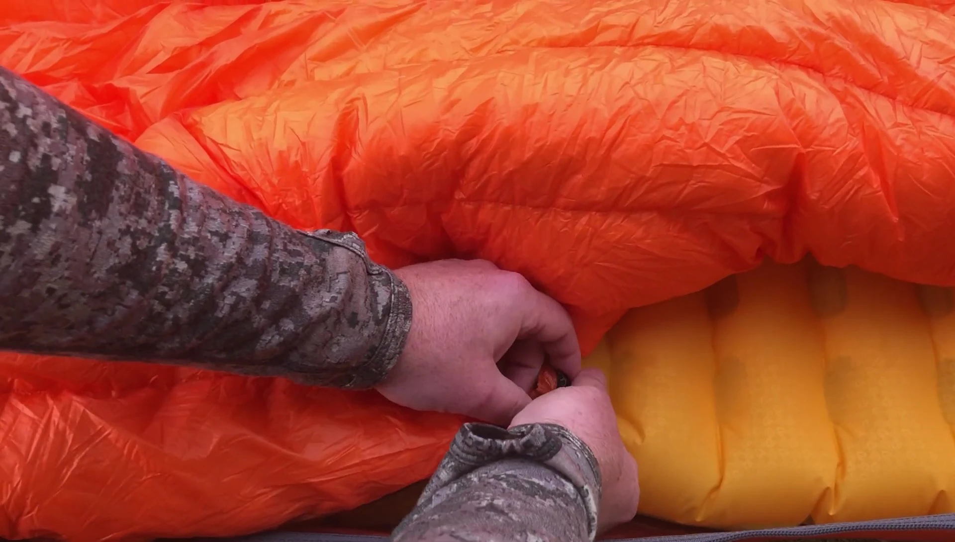 Person demonstrating quilt setup and layering