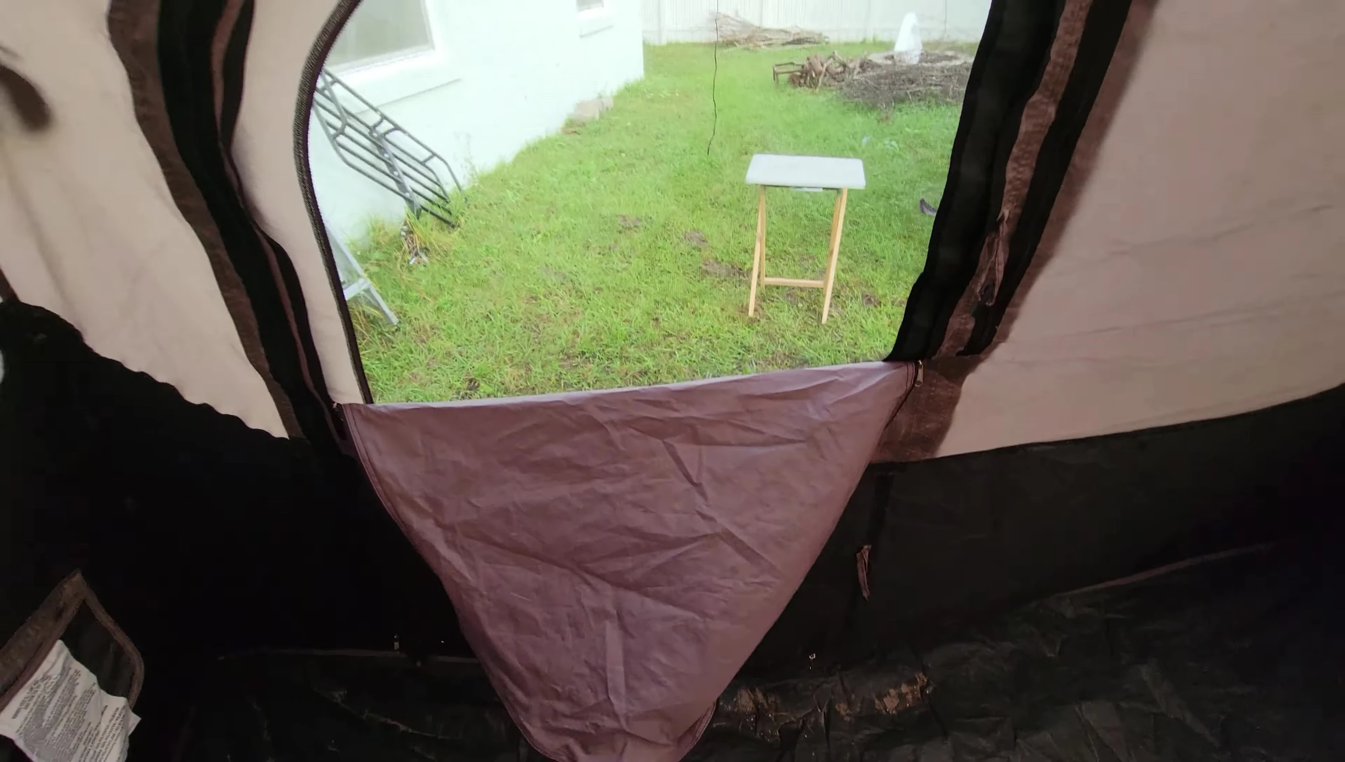 The reviewer showcasing the extensive mesh windows of the tent.