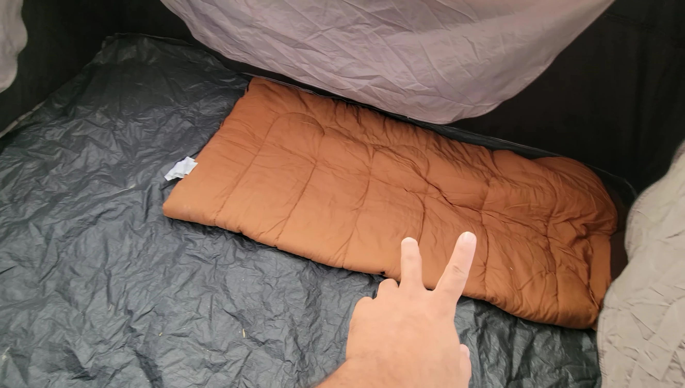 Graphic illustrating how sleeping bags are used to measure tent space.