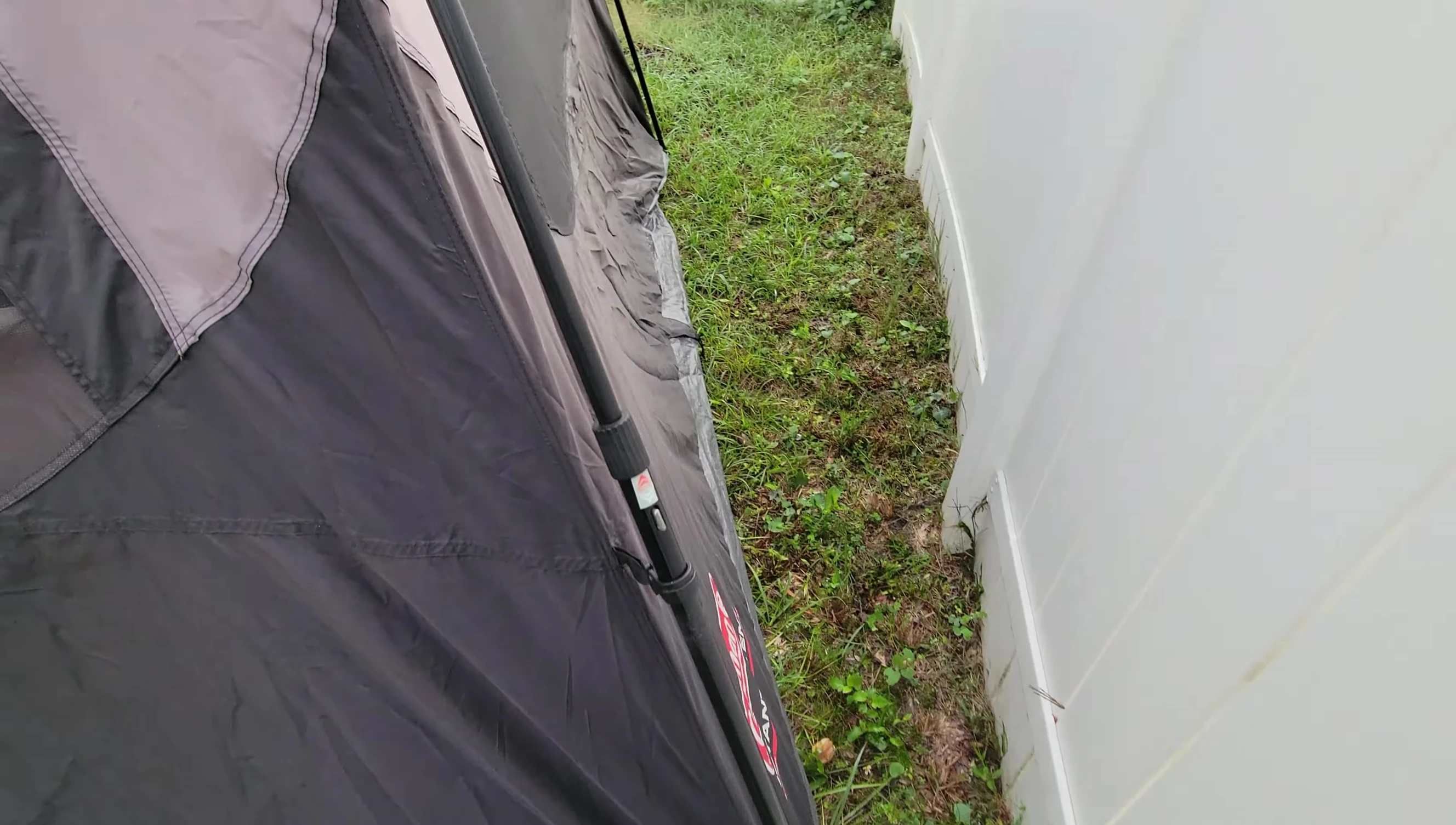 The reviewer showing the tent's structure and flexibility during packing.