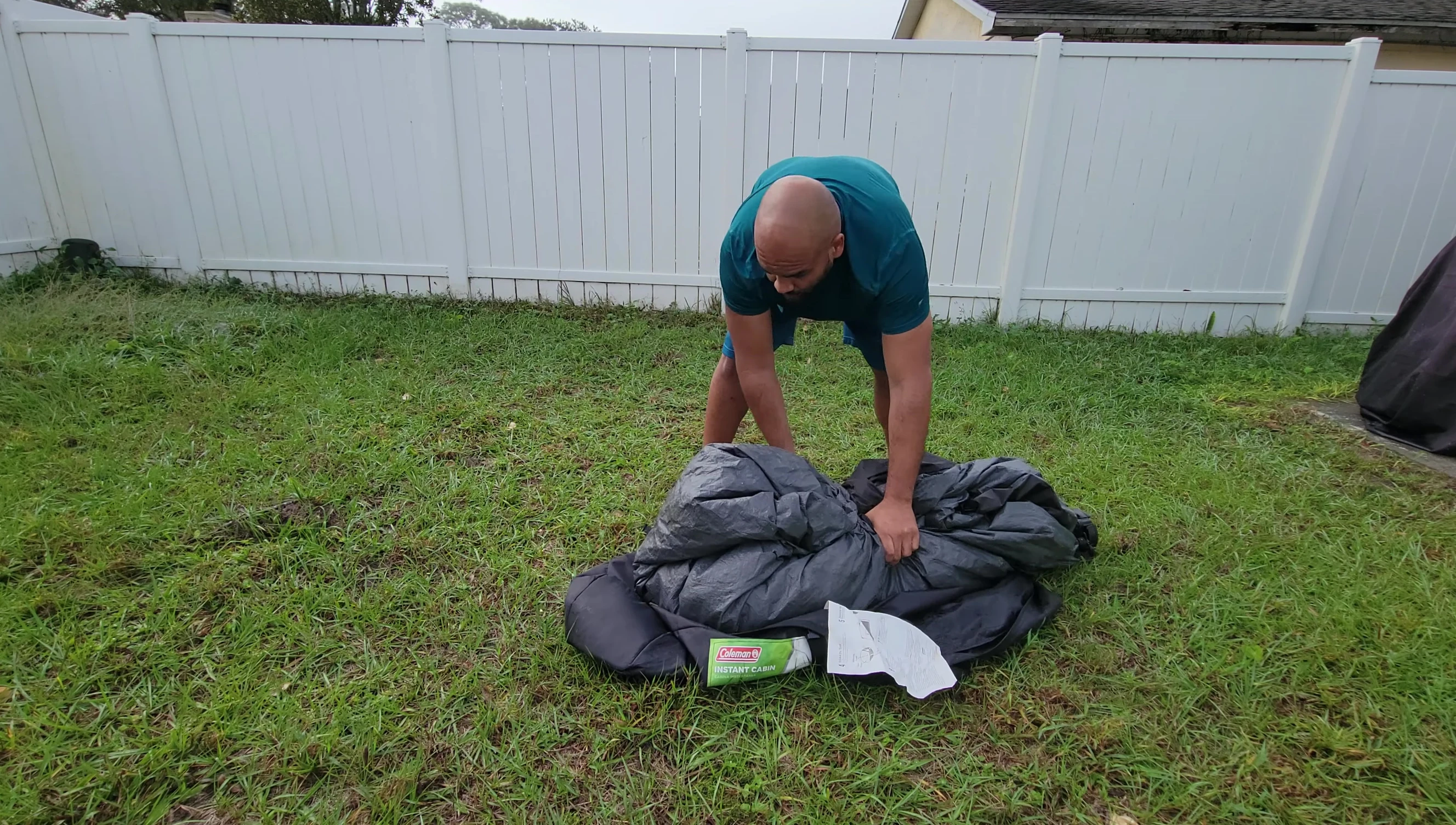 The reviewer packing the tent back into its bag.