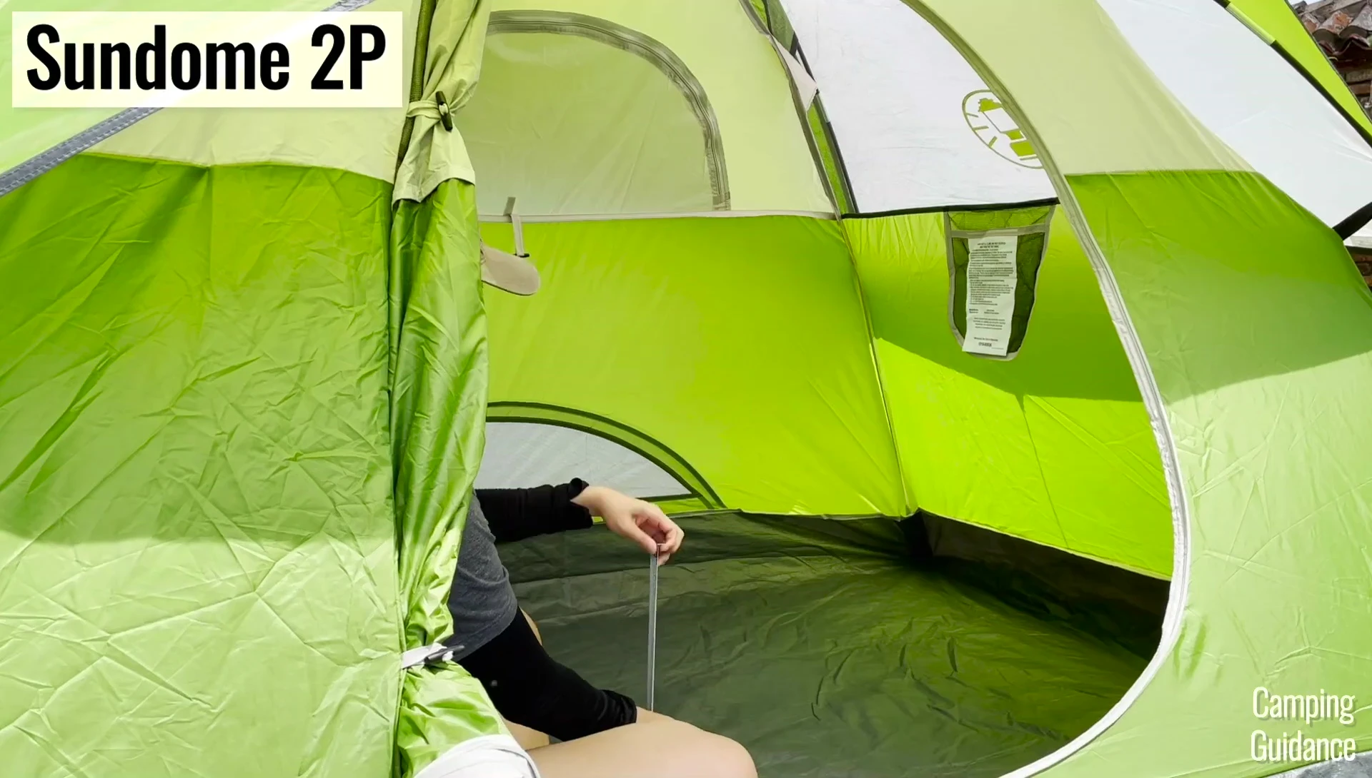 Person sitting inside the 2-person Sundome tent.