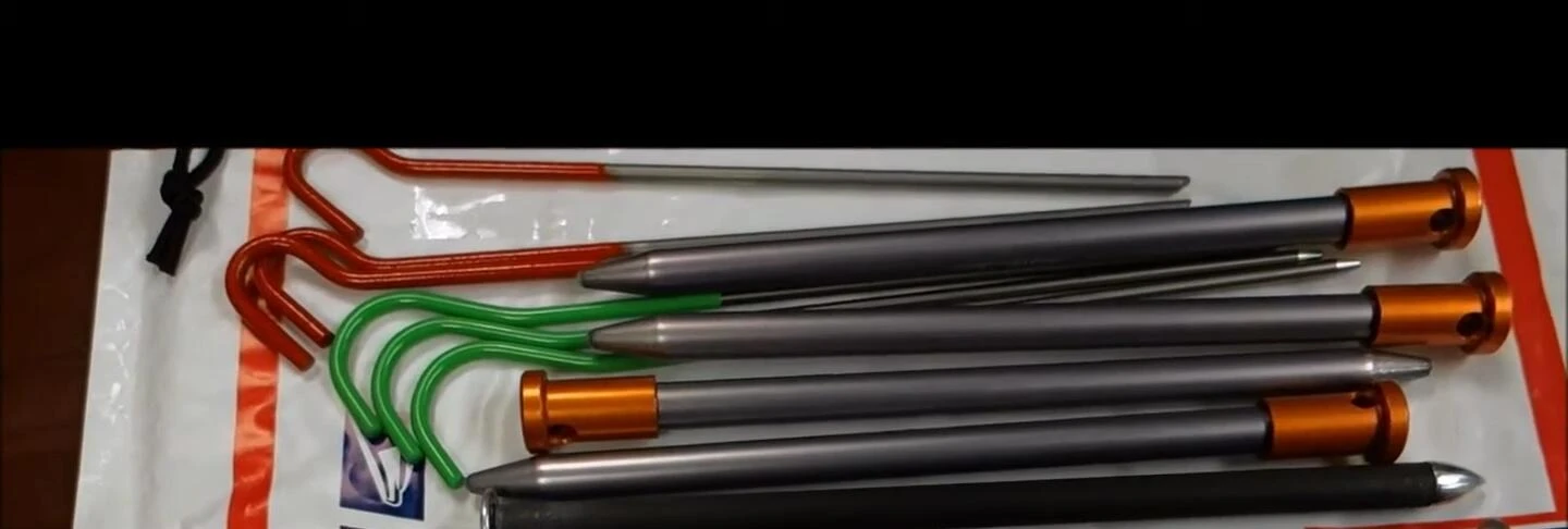 Close-up comparison of the LiteTrail (green) and Lawson (red) tent stakes.