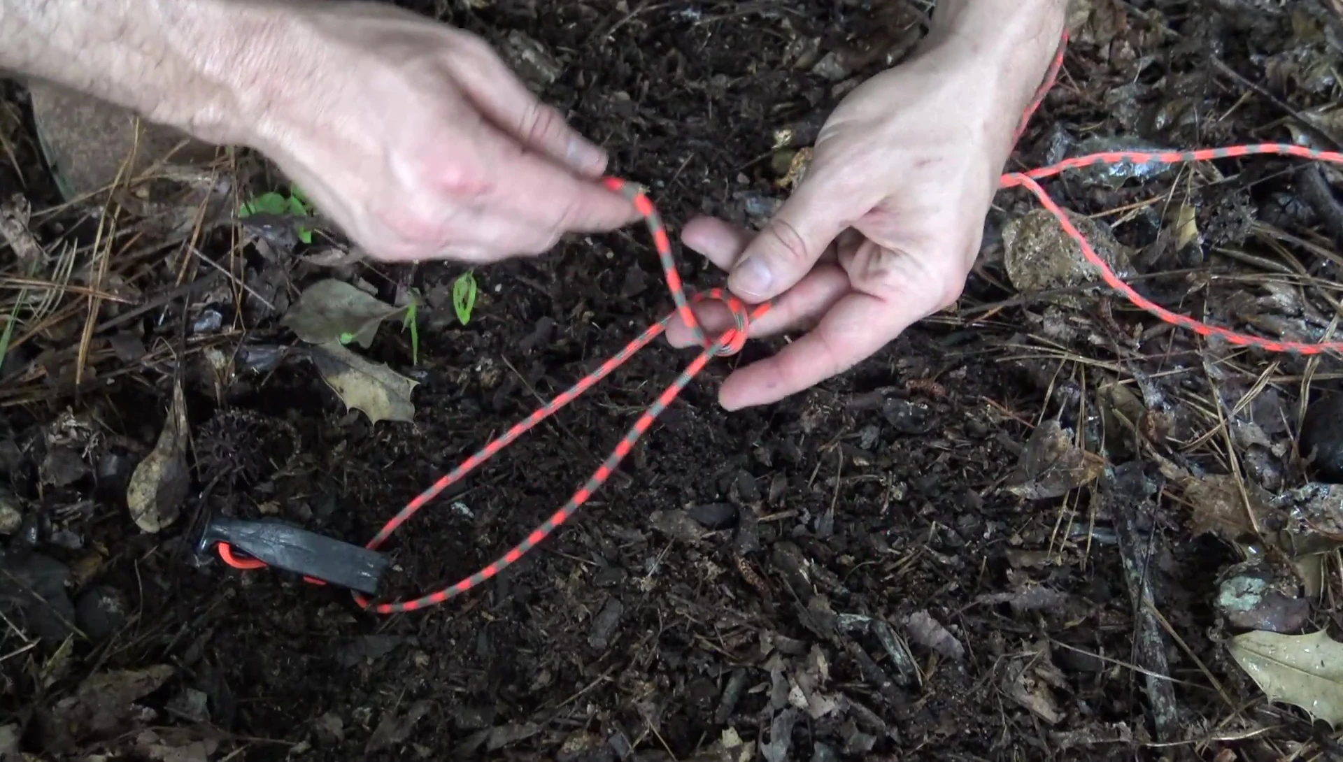 Tying a taut-line hitch to secure the guyline