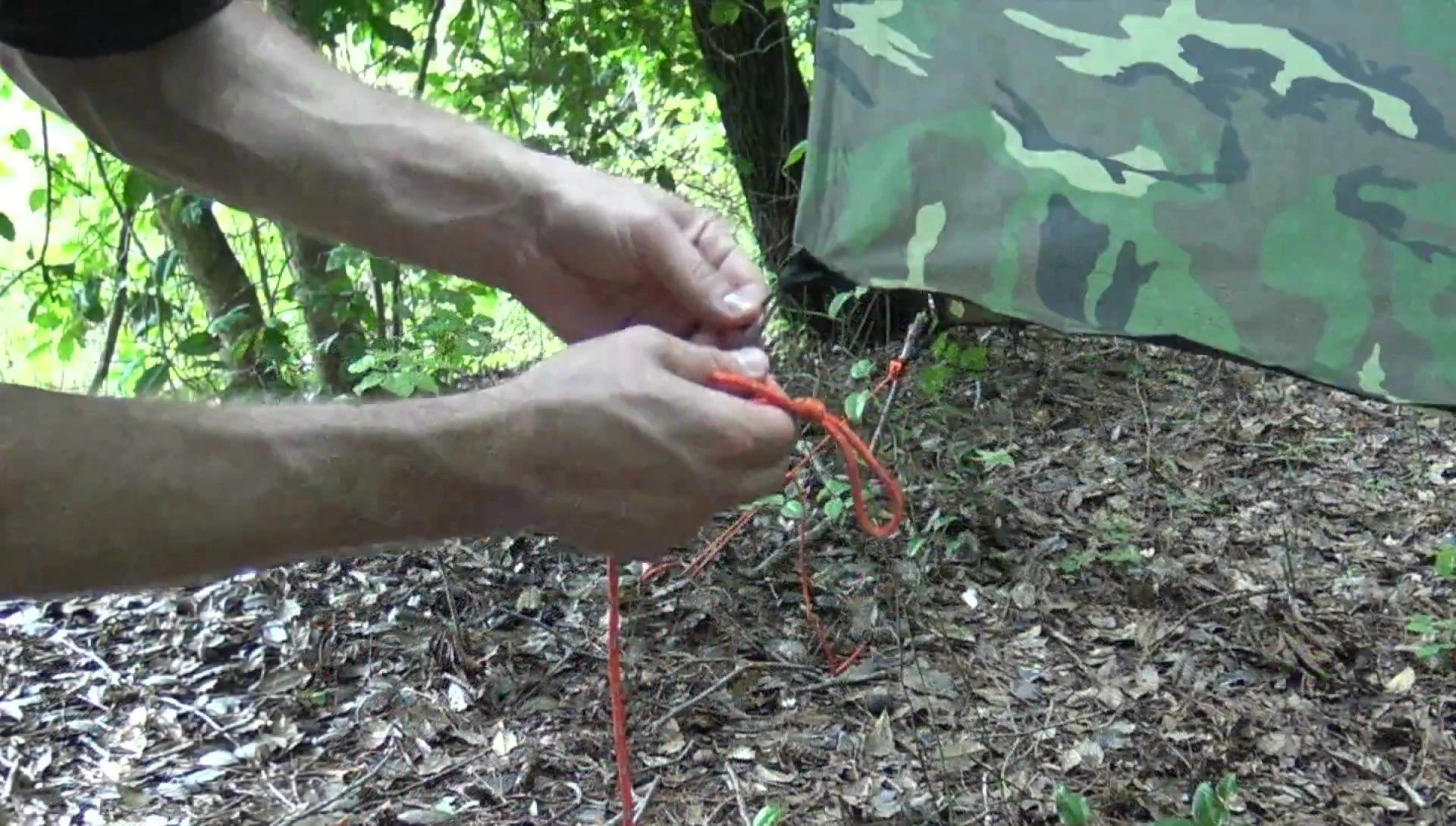 Lark's head knot securing the guyline to the tarp corner
