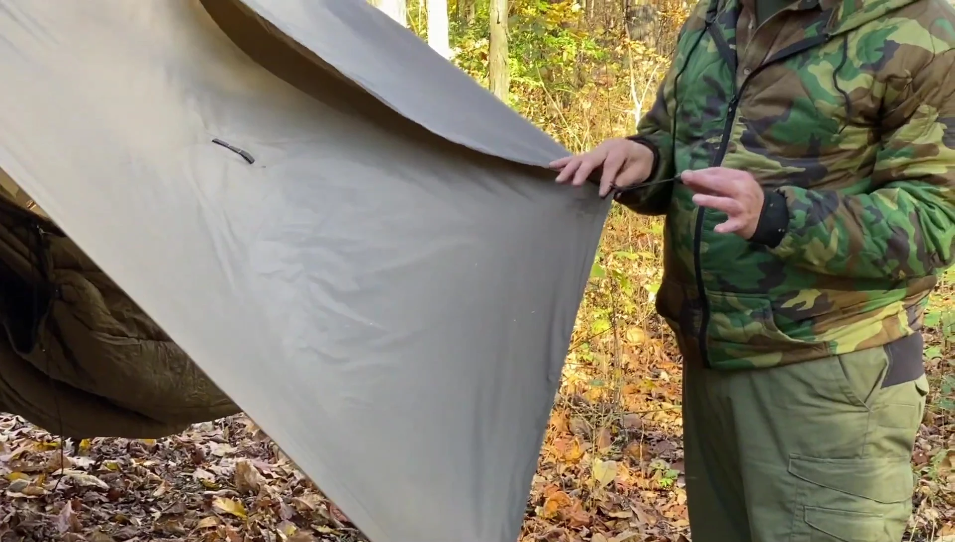 Demonstrating the tarp's additional tie-out points.
