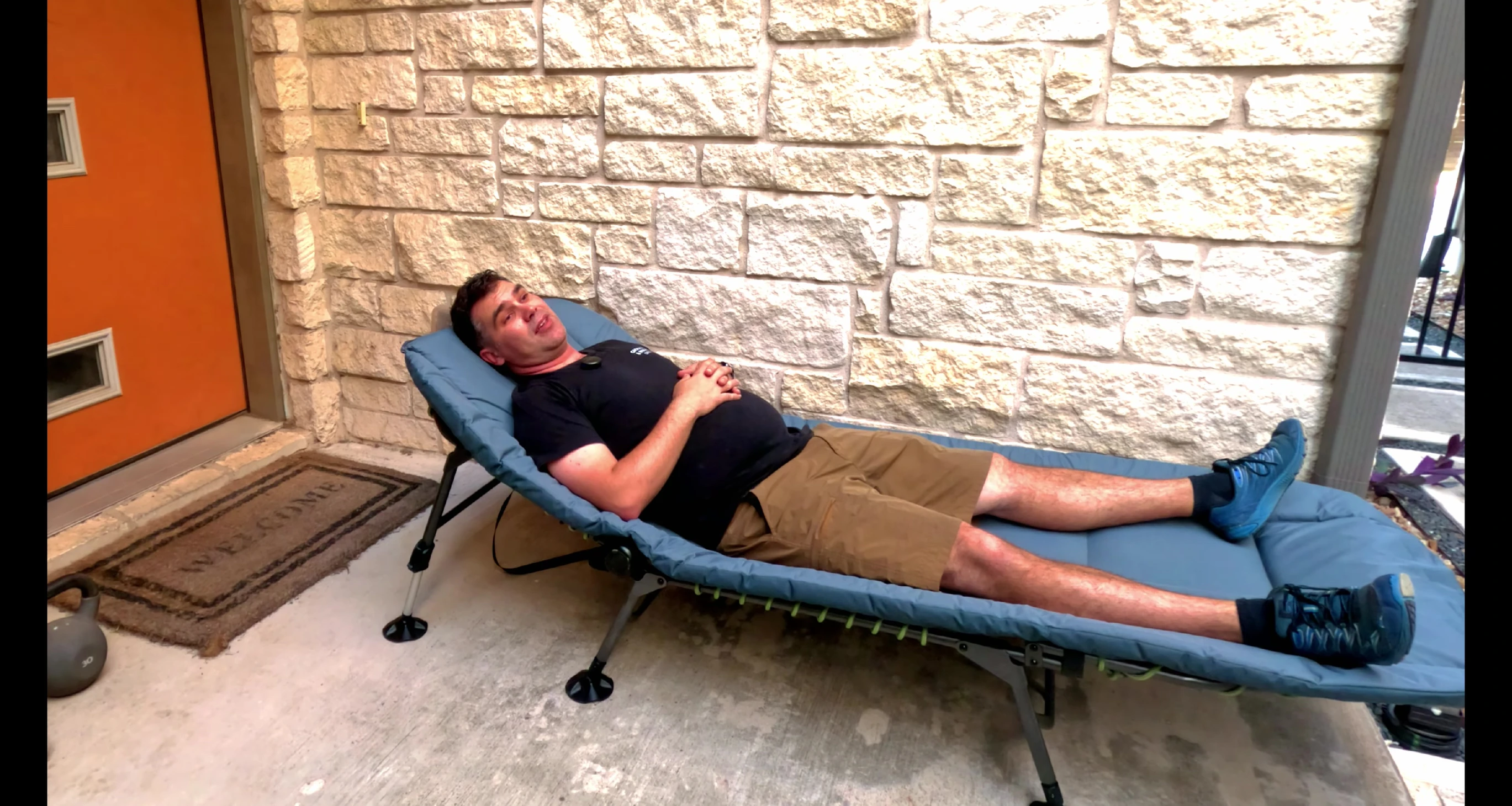 The reviewer comfortably lying in the cot.