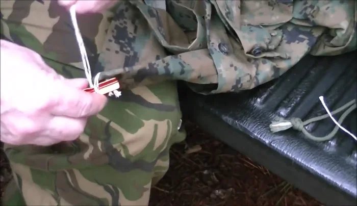 Pass the loop back through the grommet or attachment point on the tarp.
