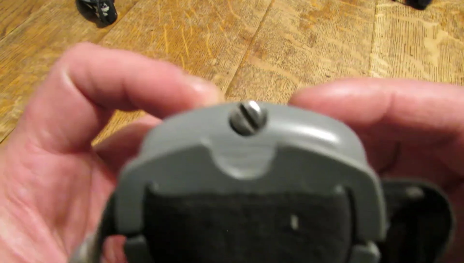 Close-up shot of the screw-on battery compartment on a Princeton Tec headlamp.